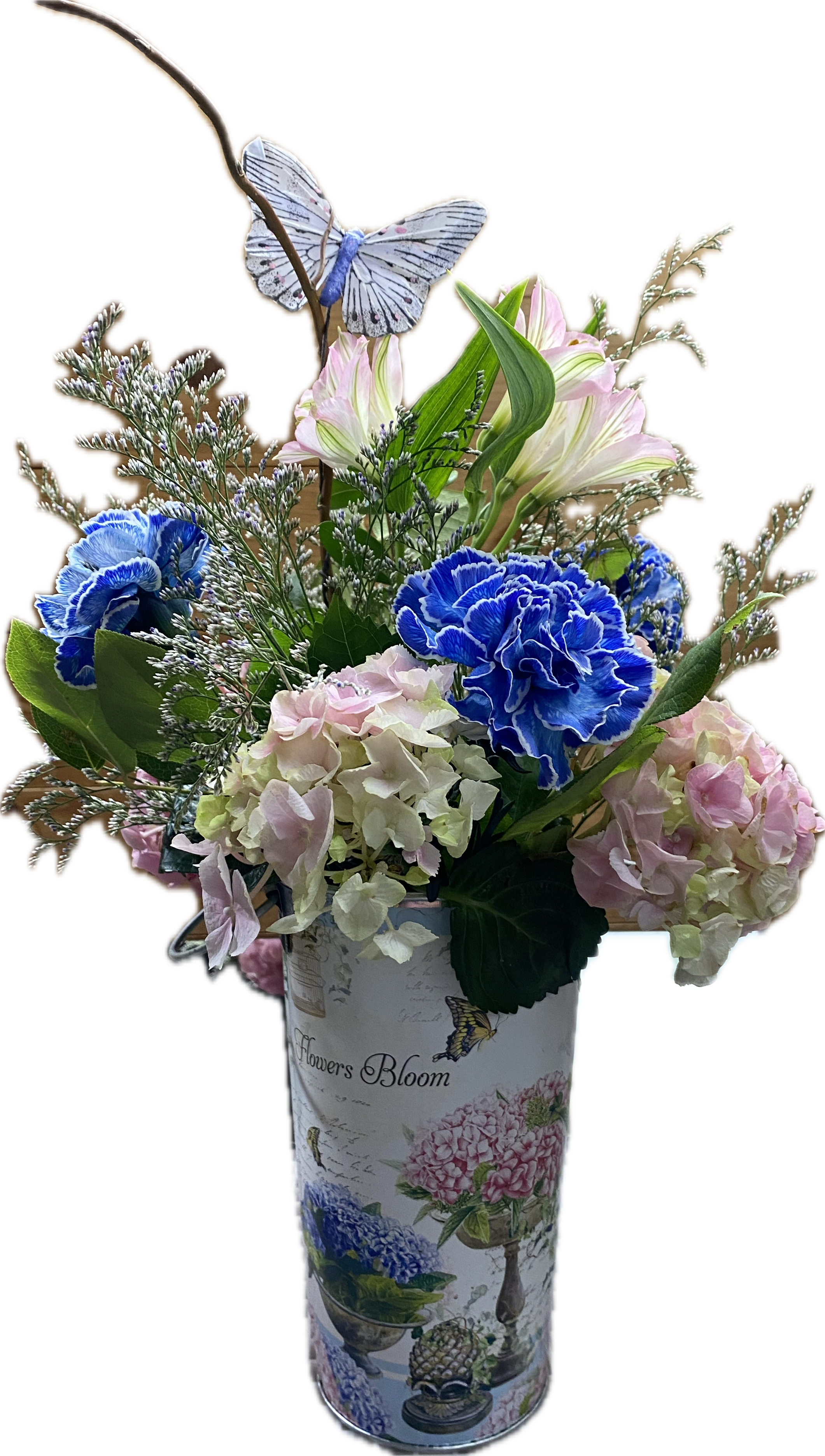 Blue and pink flowers in a decorative vase with a butterfly pick
