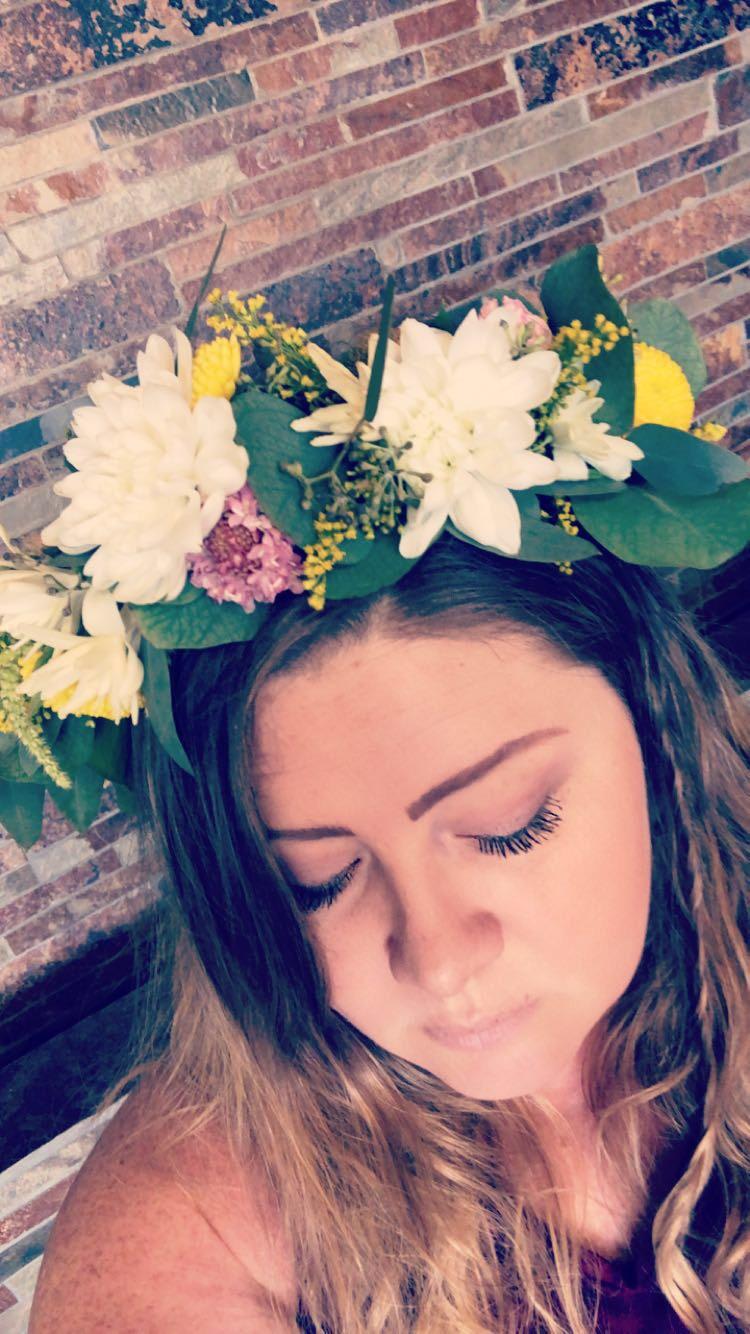 Woman wearing a white and yellow flower crown