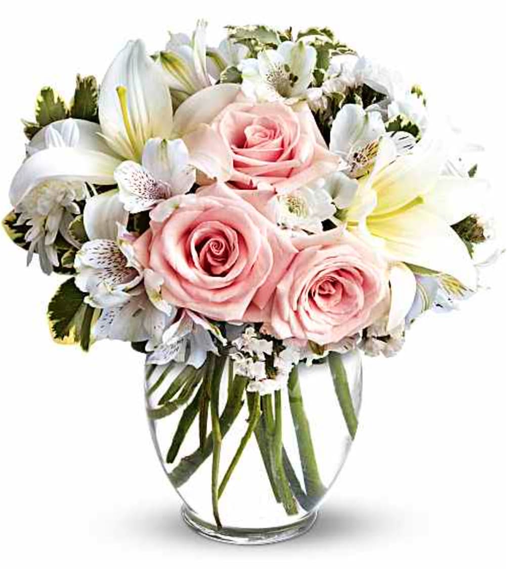 Arrive in Style Bouquet - When you want your best wishes to arrive in high style, go with this fashionable, feminine bouquet! Full and fragrant, it gathers soft pink roses with white lilies, alstroemeria and mums into a rounded ginger vase. Light pink roses, white asiatic lilies, white alstroemeria and white cushion spray chrysanthemums are mixed with white statice and variegated pittosporum in a clear, rounded vase. Orientation: All-Around