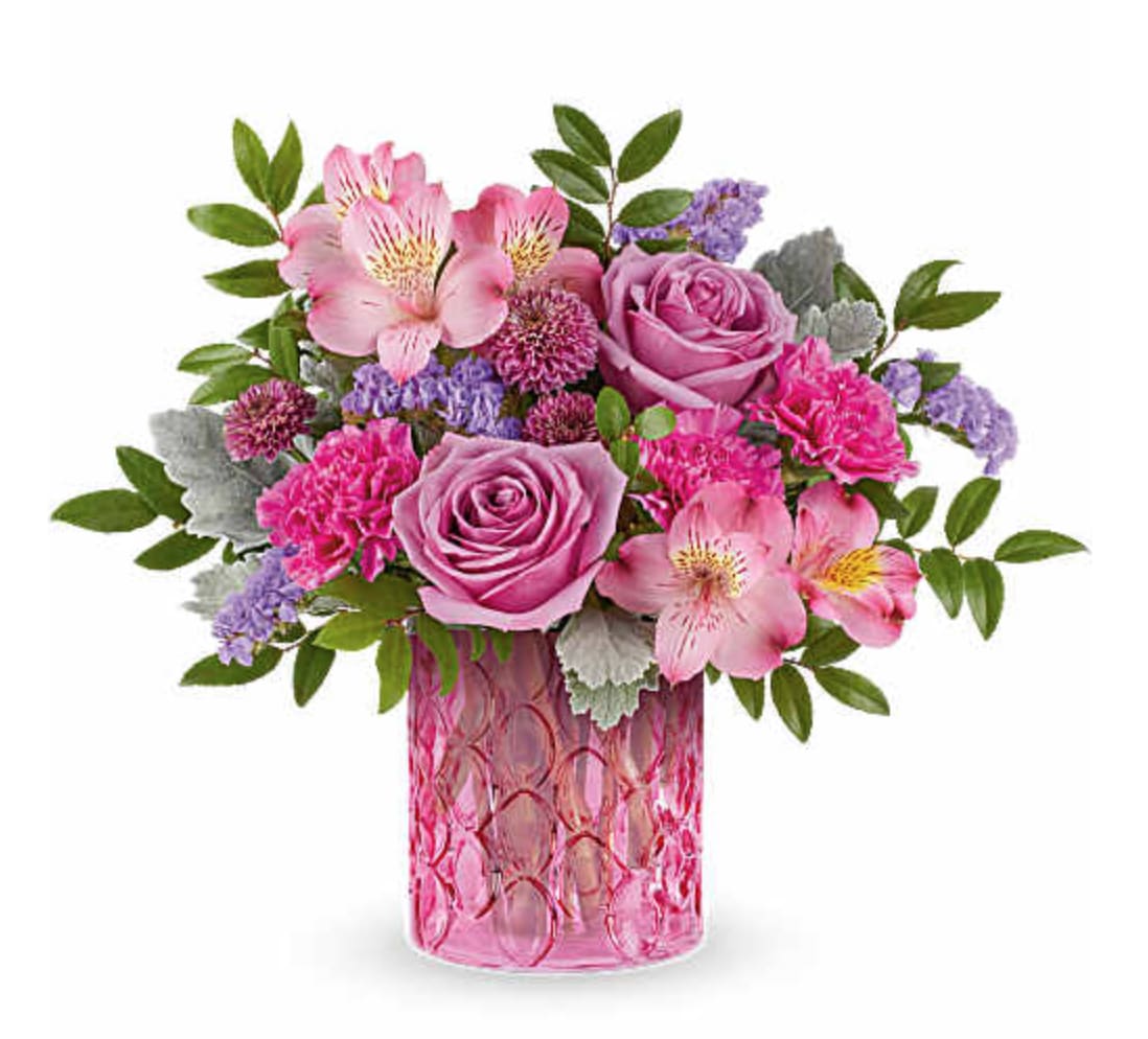 Pink Rhapsody Bouquet - Celebrate her in style with our Pink Rhapsody Bouquet, a vibrant mix of pink and lavender blooms beautifully arranged in the Pink Rhapsody Vase. This stunning Mother's Day gift adds bold color and lasting charm to any space. Our Pink Rhapsody Bouquet is a vibrant Mother's Day flower arrangement featuring lavender roses, pink alstroemeria, fuchsia carnations, purple button spray chrysanthemums, and lavender sinuata statice, accented with dusty miller and huckleberry, delivered in our Pink Rhapsody Vase. Orientation: All-Around