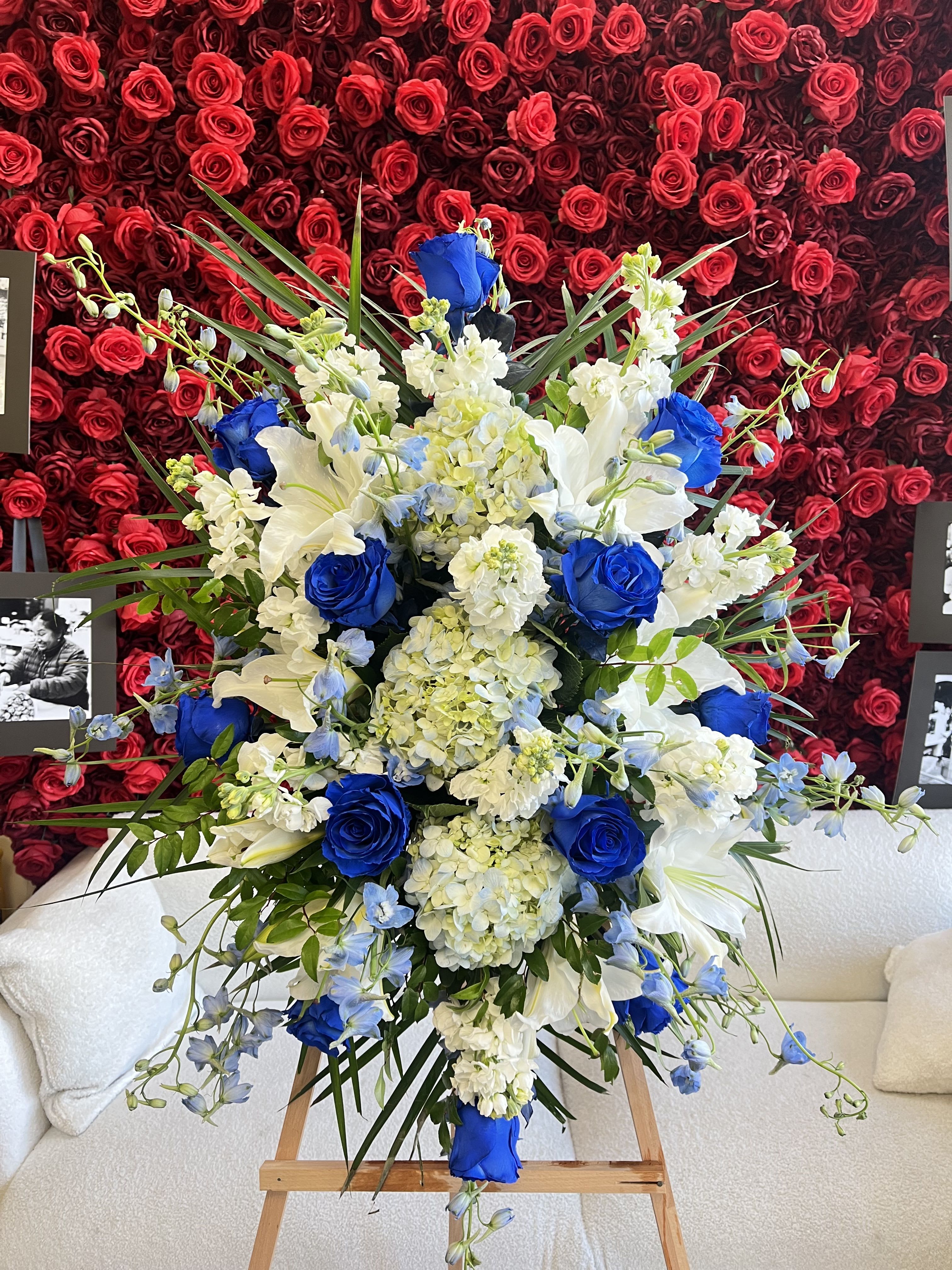Large blue, white, and cream floral spray on an easel