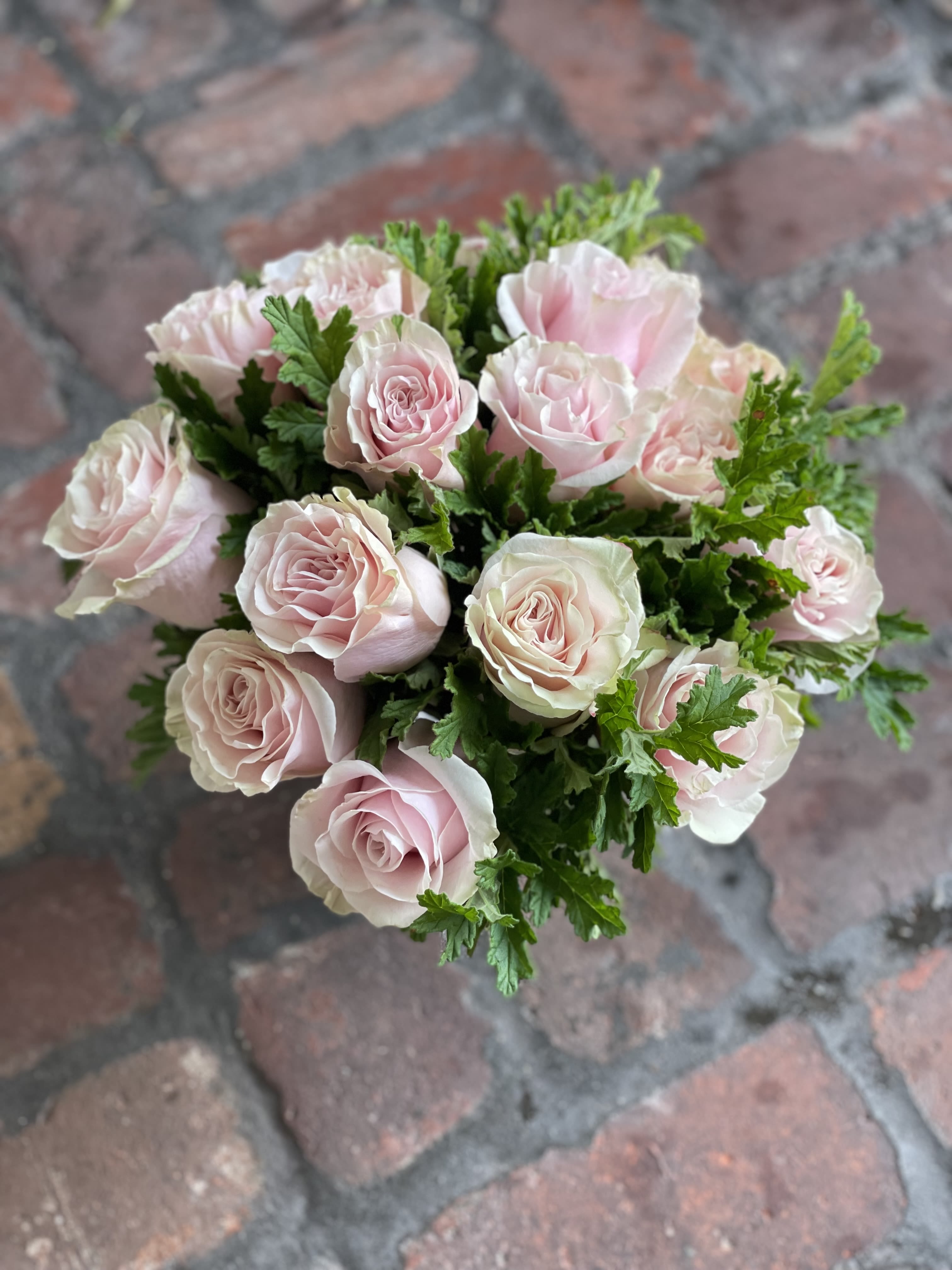 Bouquet of pale pink roses with green foliage