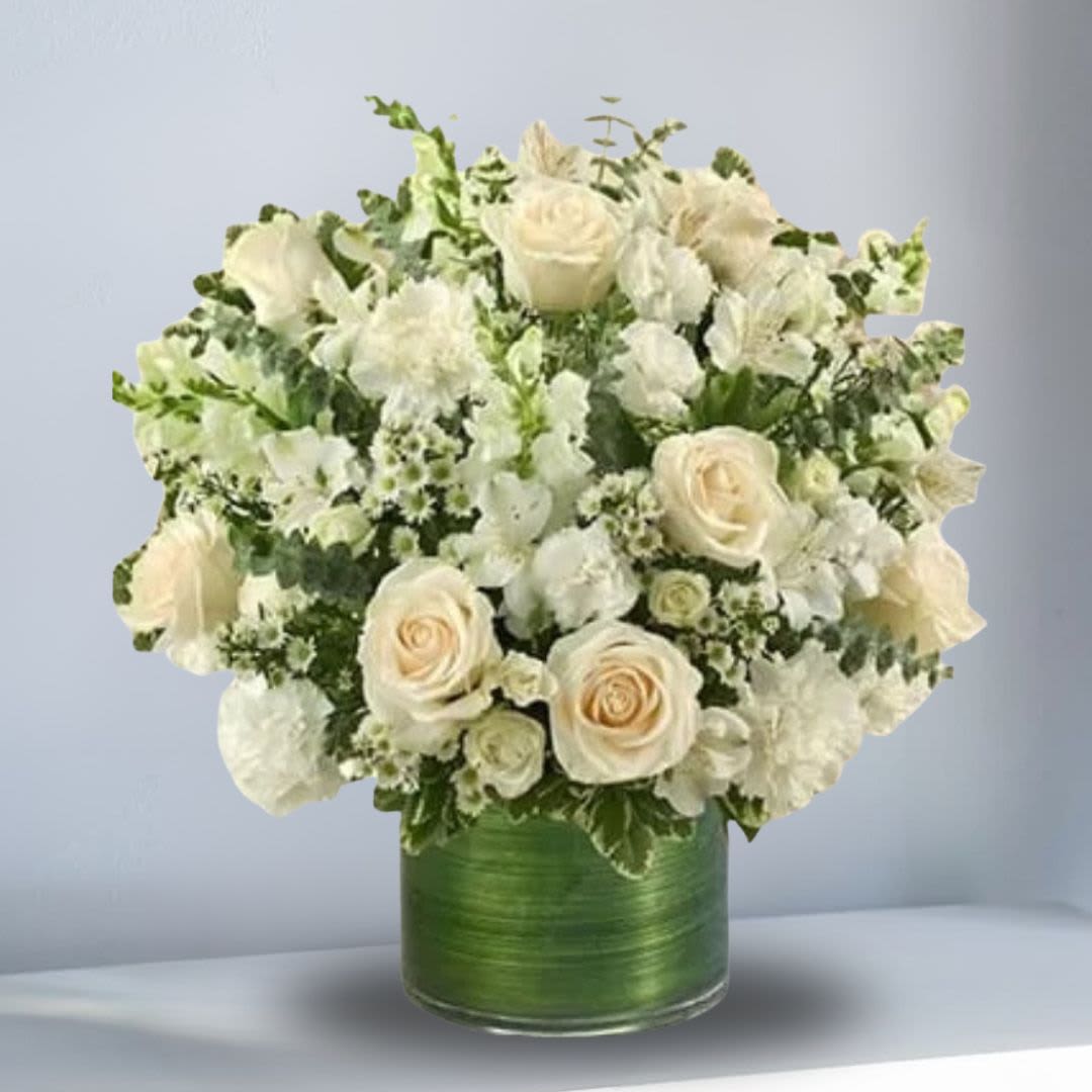 White rose and alstroemeria arrangement in a green glass vase