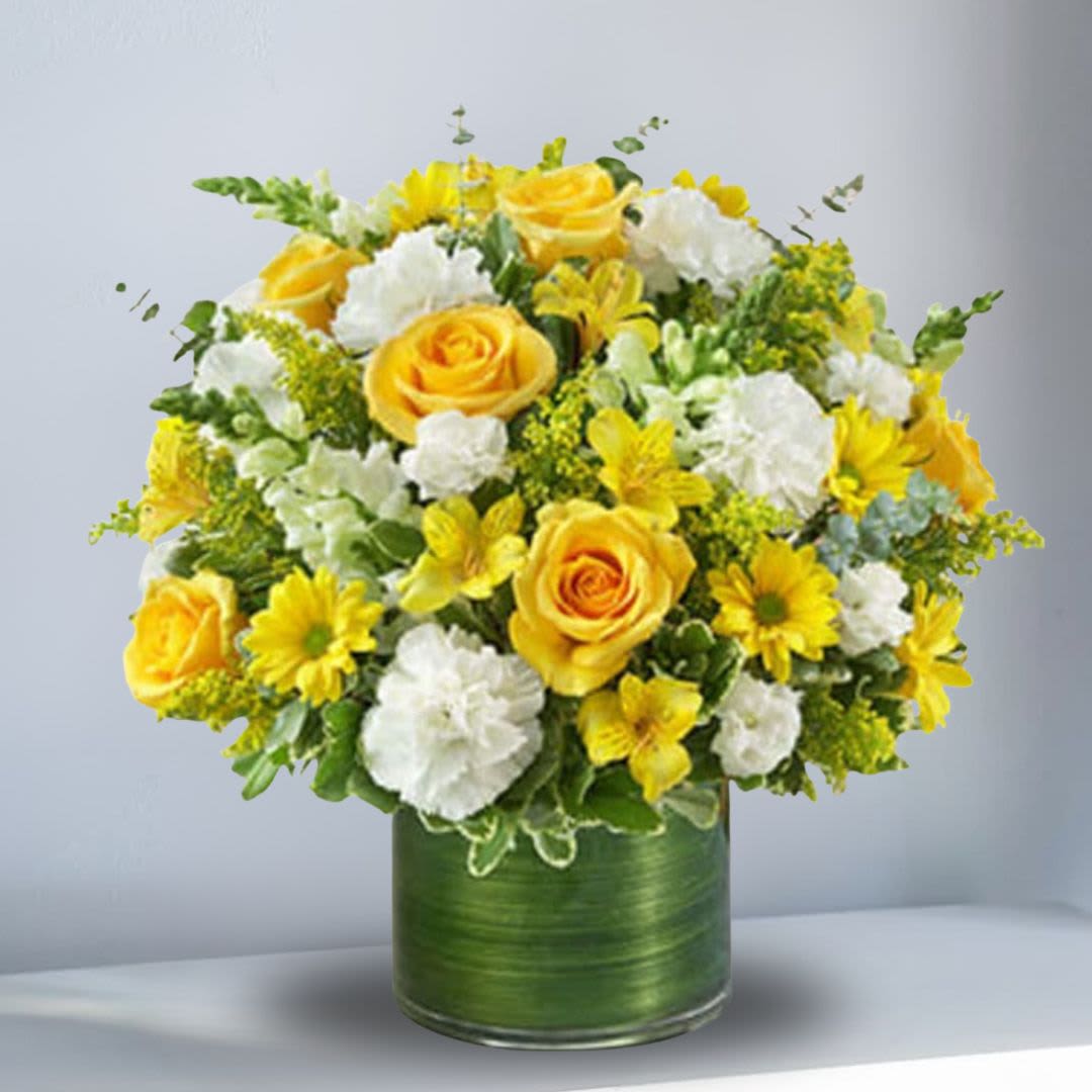 Yellow roses and white flowers arranged in a green vase