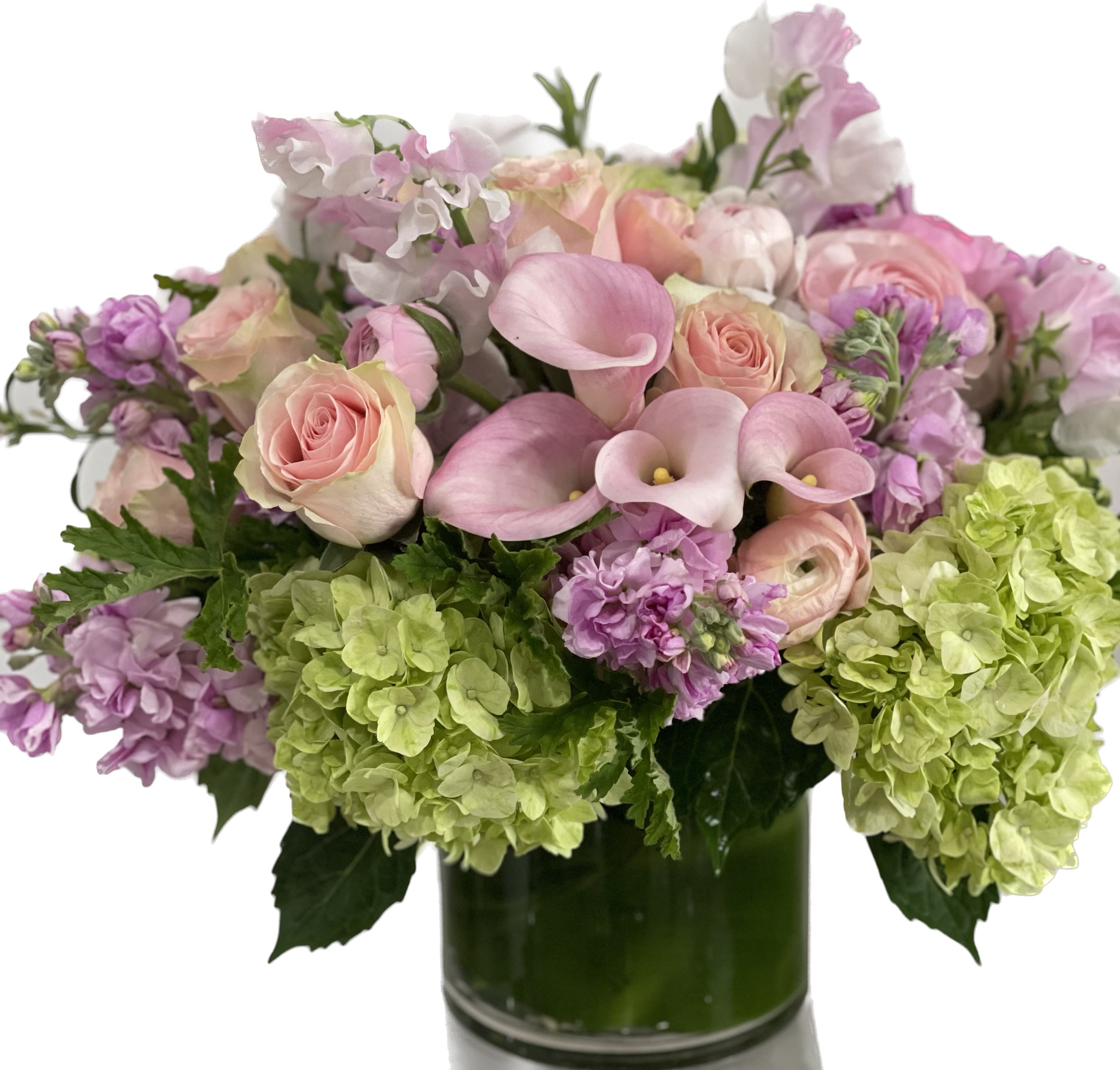 Pink roses and calla lilies with lavender blooms in a glass vase