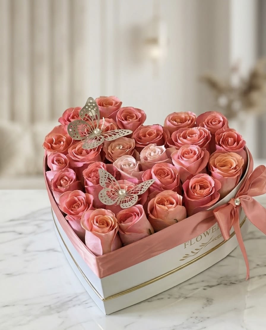 Heart Rose Box  - This heart-shaped arrangement is a stunning choice for those looking to make a lasting impression. Featuring a premium selection of blush-toned roses nestled in a designer box, it strikes the perfect balance between elegance and modern style. The addition of delicate butterfly accents and a silk ribbon finish makes this a standout piece for anniversaries, birthdays, Mother’s Day  or a thoughtful "just because" gift. 