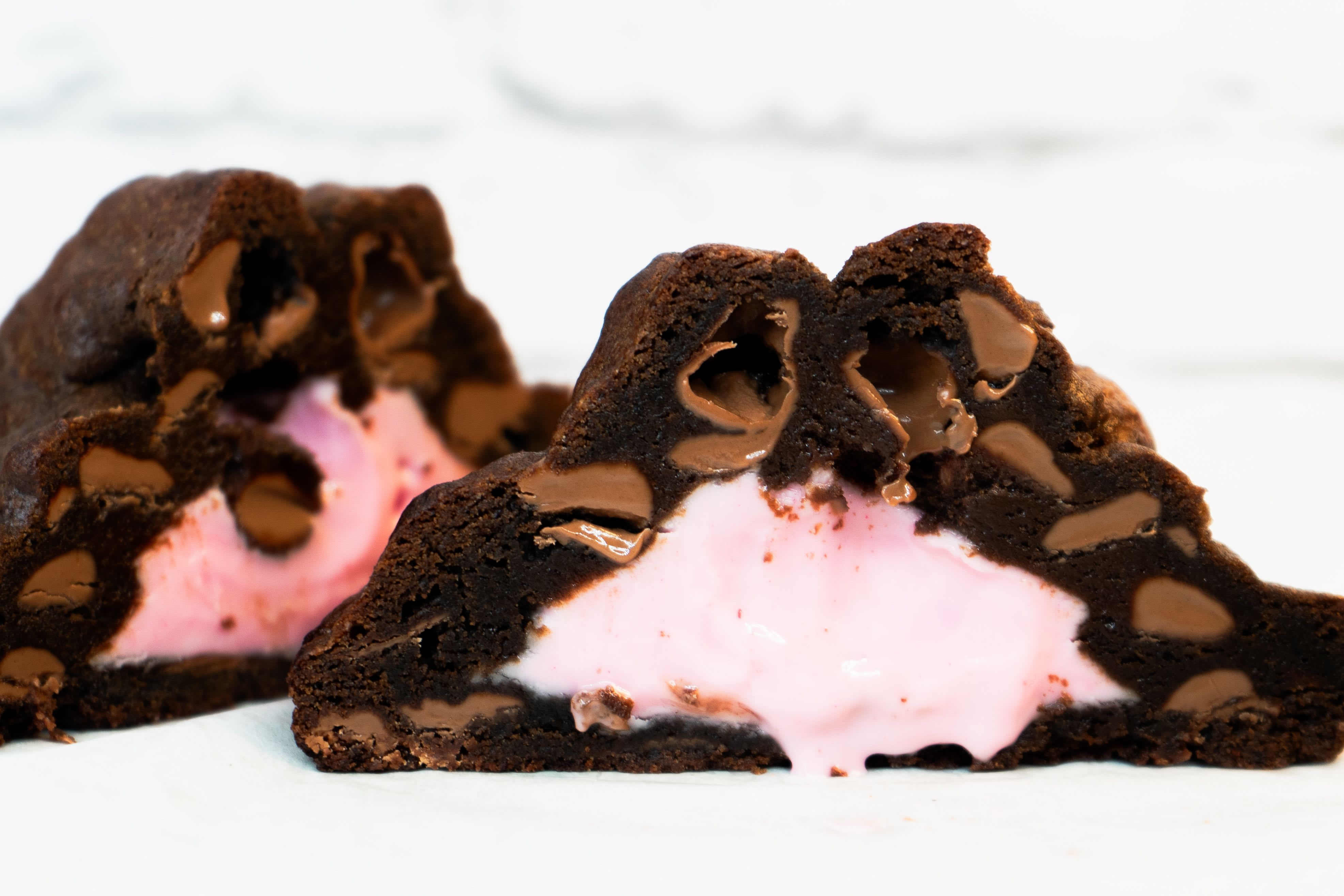 Strawberry Chocolate Lava Cookie - (NY Style) - Indulge in a luxurious twist on a classic favorite with our New York Style Choco Strawberry Lava Cookie — a rich, oversized cookie crafted to deliver the perfect balance of chocolate and strawberry in every bite.  Baked with a soft, gooey center, this decadent cookie features a luscious strawberry cream filling that melts into layers of premium chocolate chunks. The contrast between the deep cocoa flavor and the delicate sweetness of strawberry creates a unique, indulgent experience that feels both comforting and elevated.  Perfect as a standalone treat or as a delightful add-on to any floral arrangement, this cookie transforms your gift into a multi-sensory moment — combining beauty, flavor, and emotion in one unforgettable surprise.  Whether you're celebrating love, appreciation, or simply sending a sweet gesture, this cookie adds the perfect finishing touch.  - New York Style oversized cookie - Filled with creamy strawberry center (lava-style) - Made with rich chocolate chunks - Soft, gooey, and freshly baked texture - Perfect add-on for floral gifts - Individually sold (per unit) - Ideal for gifting, celebrations, or personal indulgence