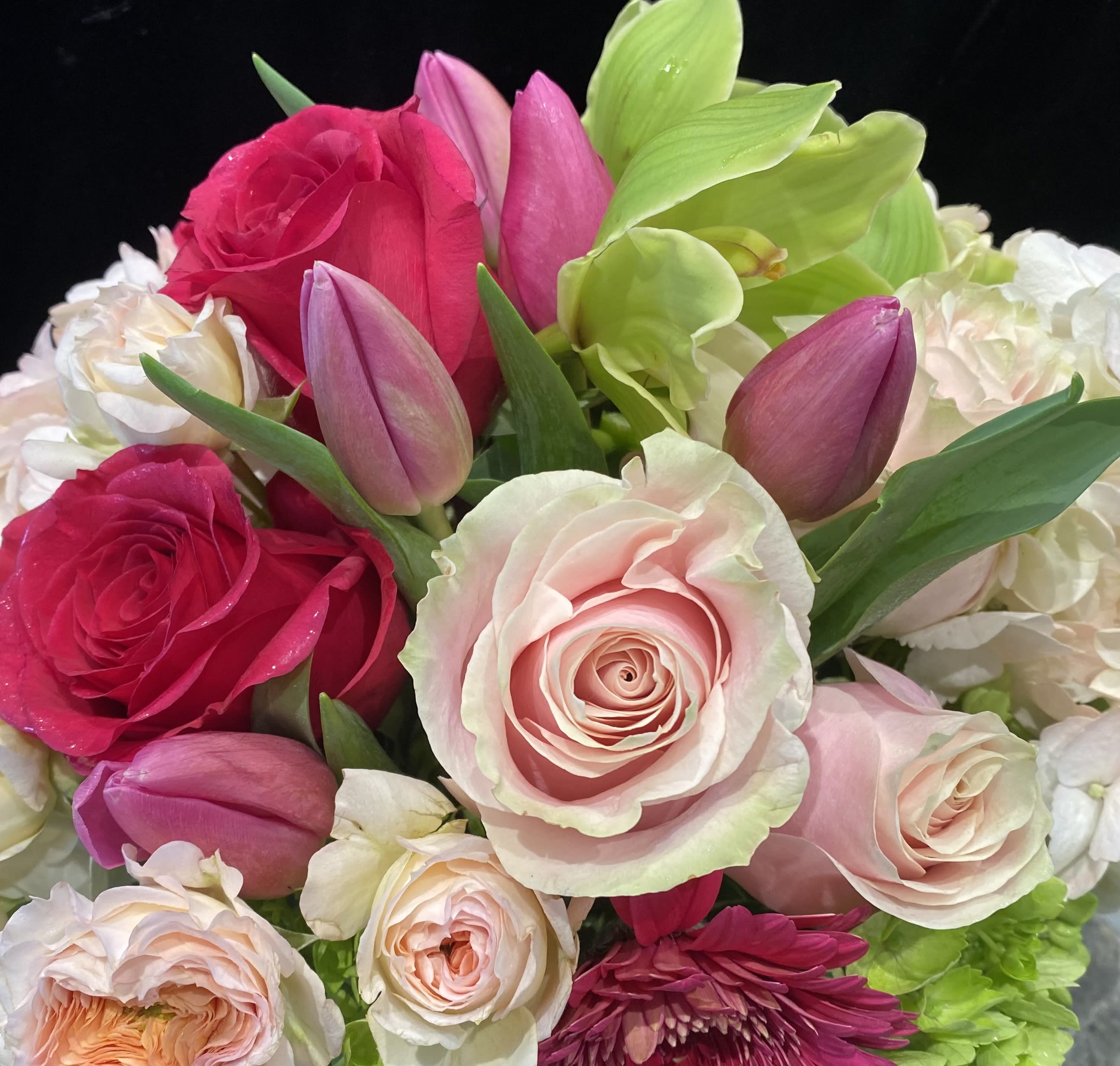 Bouquet of pink roses, tulips, and white hydrangeas