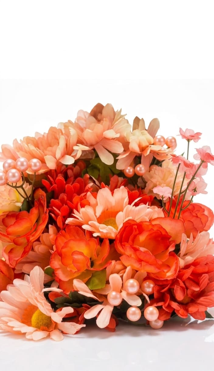 Blush Berry Box  - A bright, cheerful silk bouquet arranged low in a gift box, perfect as a birthday bouquet, thank-you gift, or springtime surprise. The Blush Berry Box pairs daisy-like blooms and layered chrysanthemum shapes in vivid orange, coral, peach, soft pink, red, yellow and touches of white to create a full, rounded presentation that immediately feels celebratory - the kind of arrangement that makes the person you're thinking of smile the moment they see it.  This dense arrangement uses high-quality silk flowers and decorative pearl-topped picks for texture and a whimsical finish, all tied together with ribbon and presented in a gift-ready box. The compact, decorative design is ideal for tabletops, mantels, or a cheerful entryway accent and keeps its color and shape without water or maintenance. Choose this as a ready-to-give option when you want a long-lasting, vibrant gift that reads bright, warm, and unmistakably festive.