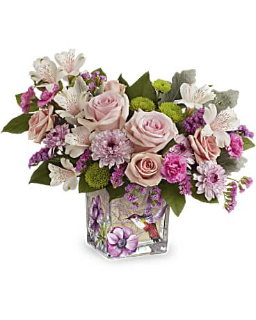 Hummingbird Surprise - We carry two wonderful vases in this line, and I'm so fond of them both!  This one here is a beautiful 5 x 5 cube vase with a beautiful hummingbird scene painted all around.  The primary colors of the glass are purple, lavender and mauve and so many flowers look amazing in this vase.  It is a keepsake you will treasure long after the flowers have faded. 