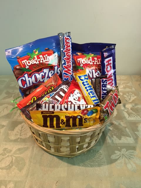 Basket filled with assorted candy bars and snack packs