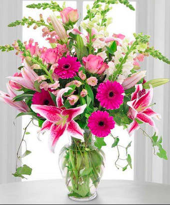 Pink Celebration - An arrangement of hot pink gerbera daisies, starfighter lilies, white and pink snapdragons, and more fill this clear glass vase and have a wonderful fragrance to fill any room!! 