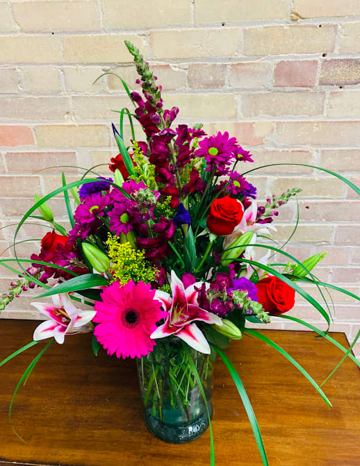 The Painted Lady - An extra large arrangement, filled with lilies, daisies, roses, snapdragons, iris, &amp; carnations. 