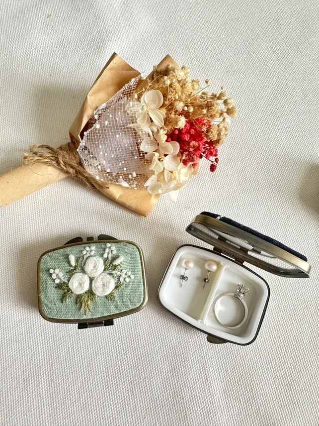 Mint Pill Box - A petite, handmade pill box dressed in pale cream, beige, and bright pink-red dried accents feels like a vintage keepsake-perfect as a Mother's Day gift, anniversary surprise, birthday present, or a "just because" token that says you care. The soft, textured palette and sheer dotted tulle overlay give the piece a romantic, delicate look that will make the person you're thinking of feel truly seen during moments of love and romance, thank-you gestures, or gentle get-well wishes.  Wrapped in brown paper and tied with twine for a handcrafted finish, the pill box arrives ready to gift and to tuck into a purse or bedside table as a lasting, low-maintenance memento. Sized for intimacy rather than grand display, it's a thoughtful choice for weddings, proposals, Valentine's Day, or simply to say thinking of you; add a personal note at checkout to customize the sentiment.