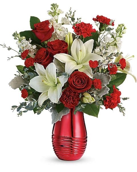 Radiantly Rouge Bouquet - Sweep them off their feet with this luxurious bouquet of red roses and fragrant white lilies, presented to perfection in a radiant rouge ceramic vase! Red roses, white asiatic lilies, red carnations, red miniature carnations, and white stock are arranged with dusty miller, parvifolia eucalyptus, and lemon leaf. Delivered in a Radiantly Rouge Vase.