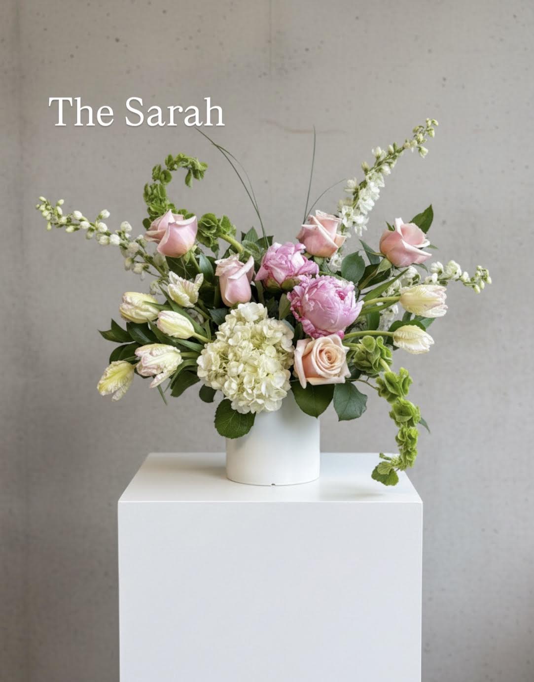 The Sarah - The Sarah. Inspired by Megan’s mom whose strength and kindness shine in everything she does. Featuring Sarah Bernhardt peonies that open beautifully, alongside pink roses and tulips.