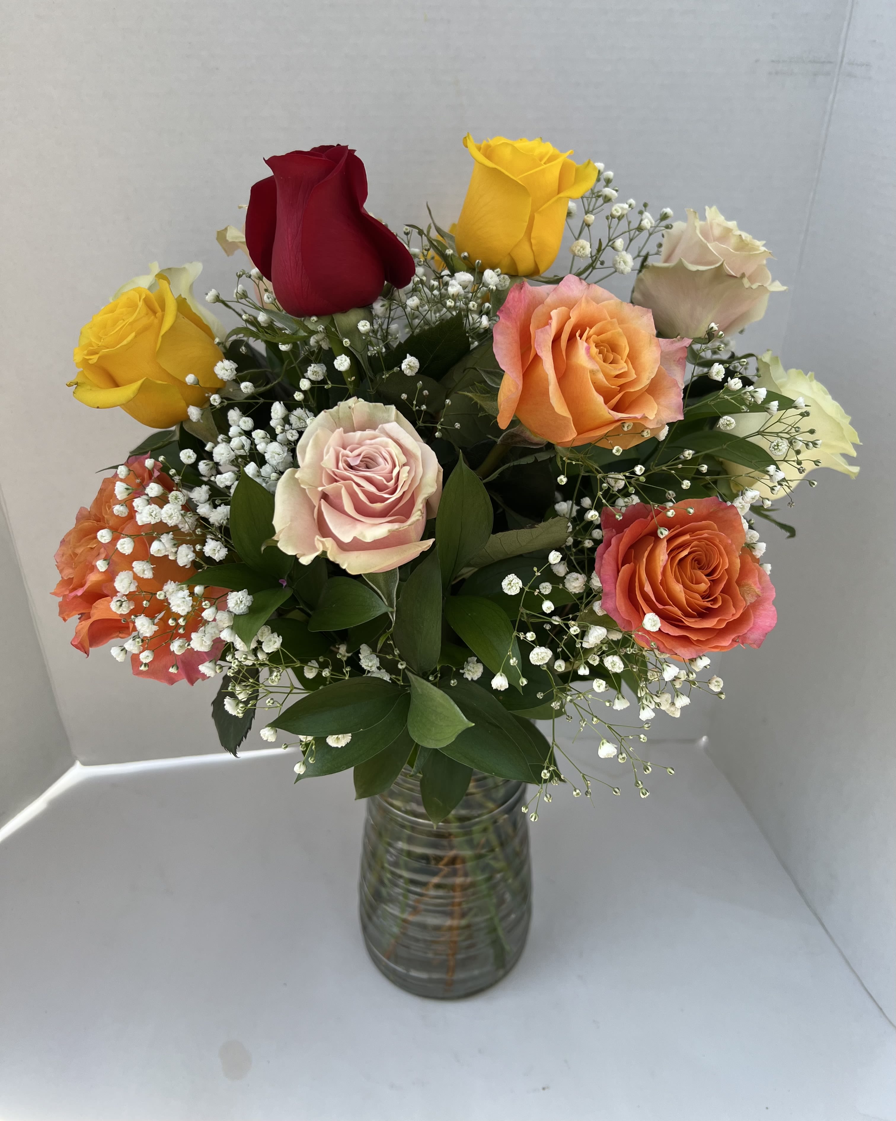Colorful Mixed Roses  - The roses are artfully arranged in a classic vase and accented with delicate filler flowers such as baby’s breath or wax flower.  Because colors are designer’s choice, every arrangement is unique—crafted with care and creativity to ensure a beautiful, fresh display perfect for any occasion.
