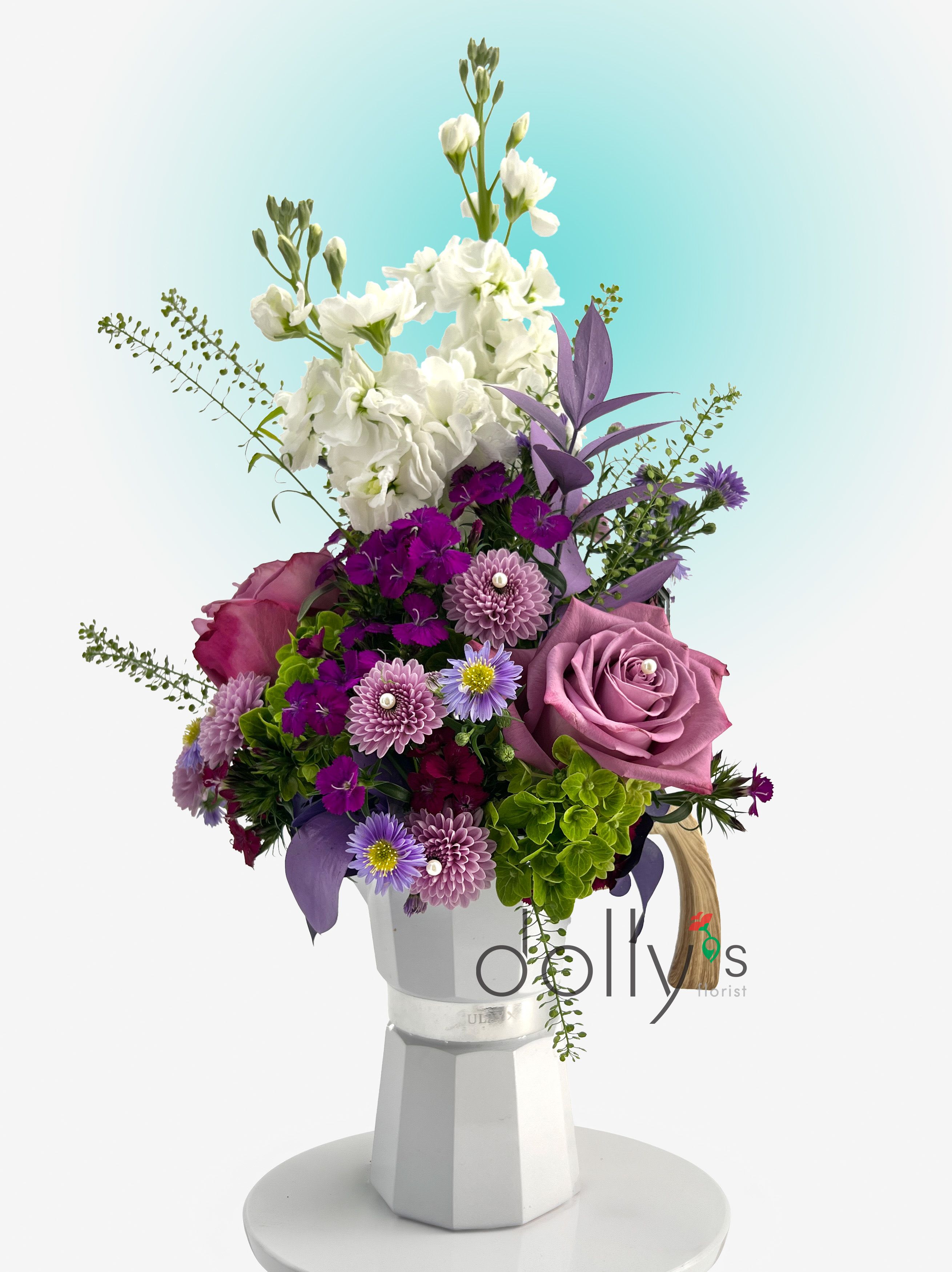 Purple and white mixed bouquet in a white vase