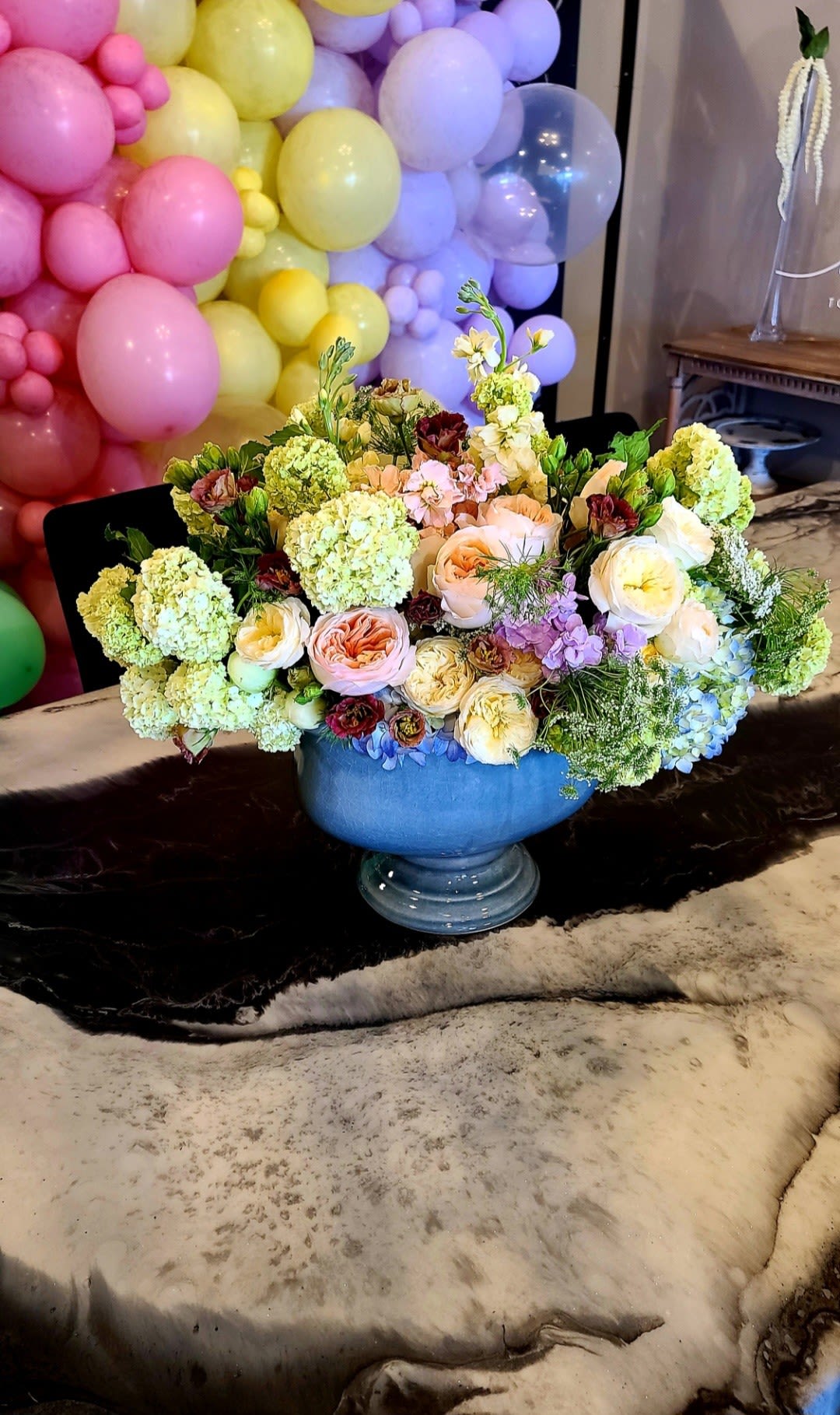 Stella's Garden - Make Mother’s Day unforgettable. Stella's Garden is our signature bouquet for Mother’s Day — a romantic blend of garden roses, fluffy viburnum, airy stock, and dancing queen anne’s lace to inspire awe and gratitude. Designed in a beautiful footed ceramic bowl, this arrangement is the perfect showstopper for Mom.  Each arrangement is handcrafted and one-of-a-kind, with seasonal blooms that may vary but will always capture the same magical spirit.