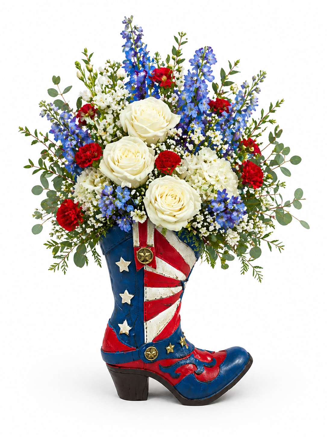 Patriotic Boot - A fun and eye-catching floral arrangement designed in a decorative cowboy boot, perfect for adding a touch of charm and personality. Featuring a beautiful mix of blooms in coordinating colors, this arrangement combines classic flowers with a playful, western-inspired style.  Thoughtfully arranged with fresh greenery and seasonal accents, the design is full, vibrant, and well-balanced—making it a unique statement piece. Ideal for celebrations, gifts, or themed events, this boot arrangement is both memorable and full of character.