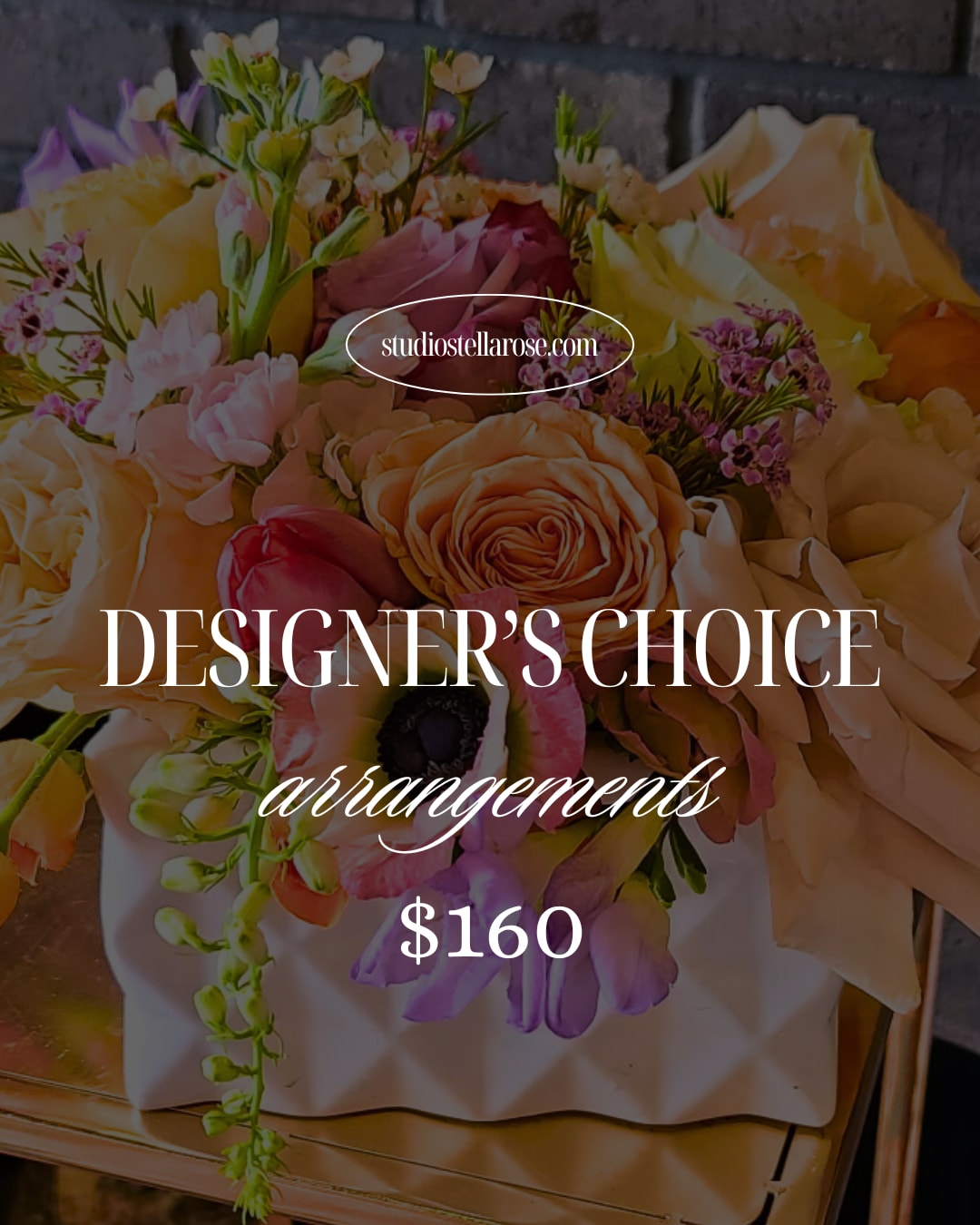 Colorful mixed flower arrangement with roses and ranunculus in a white textured vase