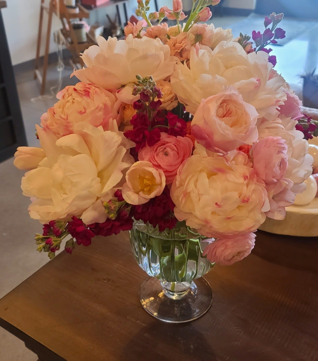 Peony For Your Thoughts? - A swoon-worthy swirl of pillowy peonies, ranunculus, and buttery blooms in shades of blush, cream, and soft coral, kissed with pops of deep berry. It's like a love letter in flower form- flirty, fluffy, and just a little dramatic (in the best way). Perfect for making hearts skip a beat or brightening a random Tuesday. **Designers Choice**