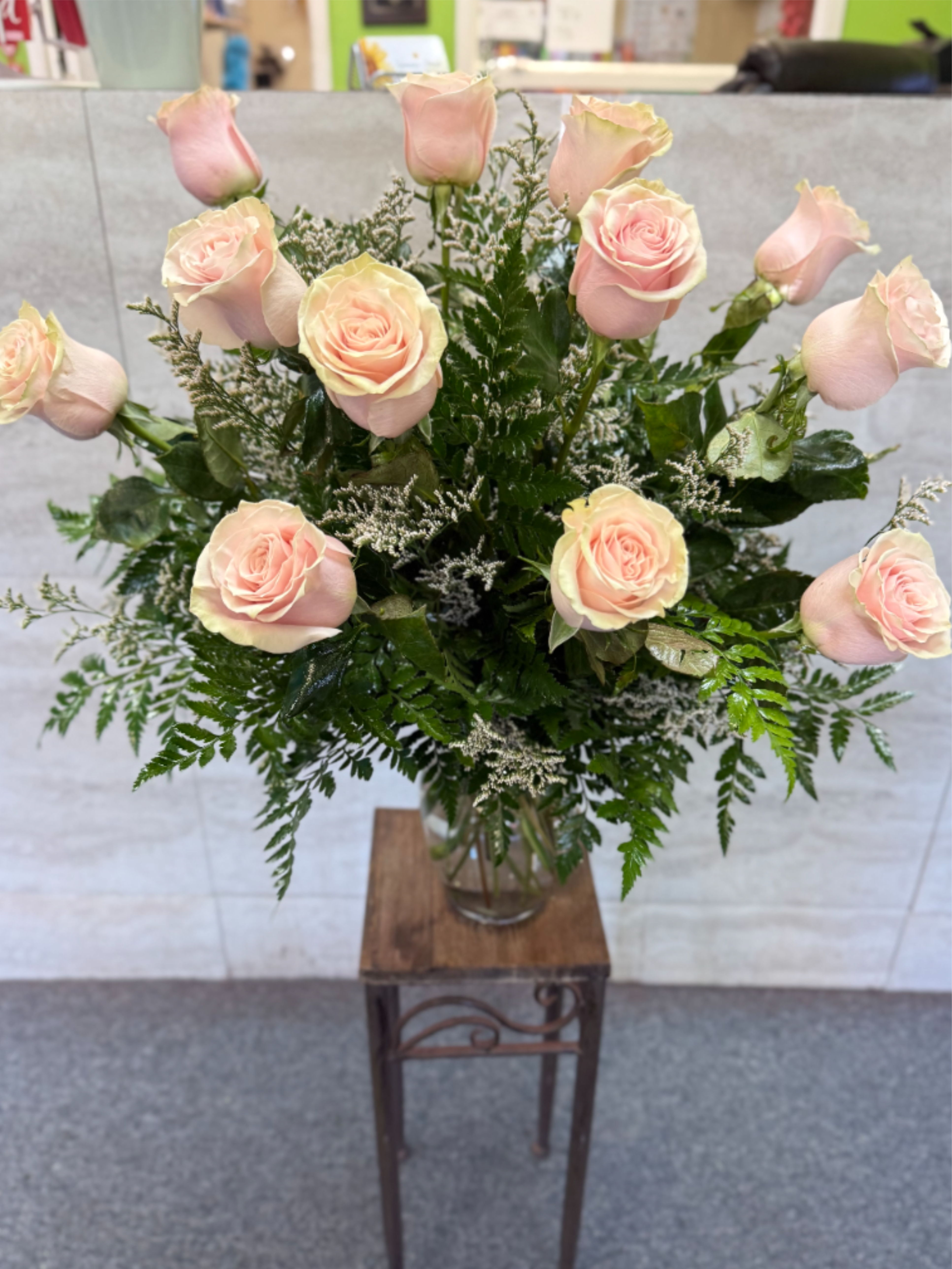 Dozen's Light Pink Roses  - (ALL-ROUND) Soft pale pink roses with white filler and dark greenery in a vase-romantic, elegant and versatile for Mother's Day, anniversaries, birthdays, get well or any loving occasion.  