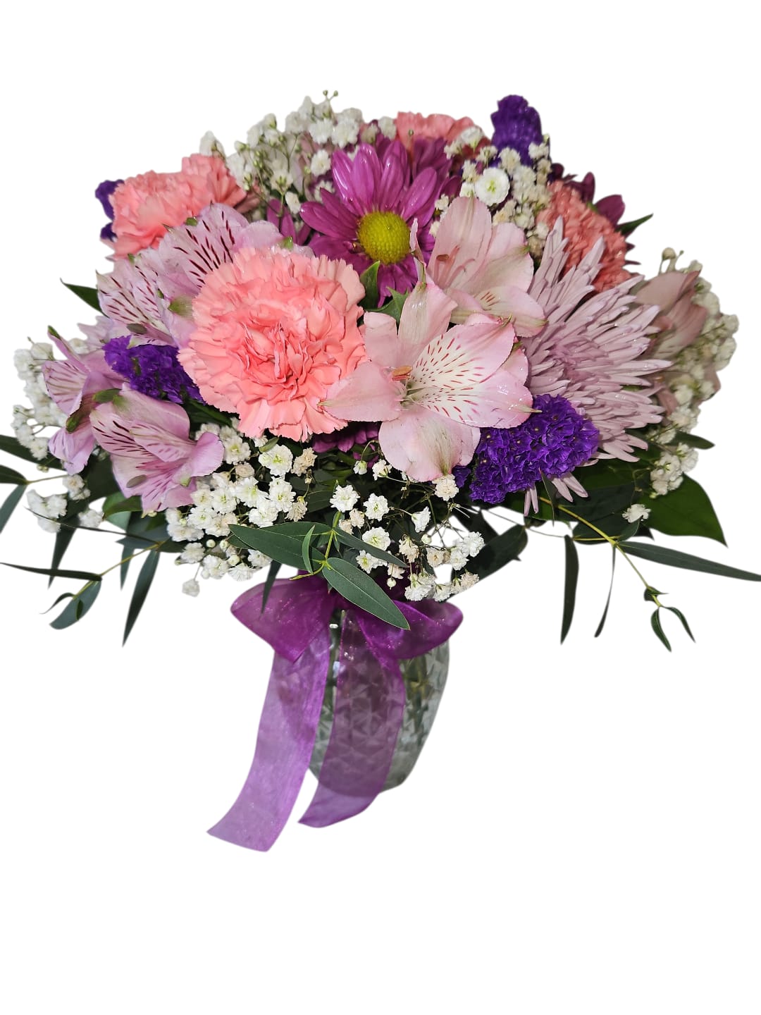 Thoughtful Surprise - Sweet and full of gentle beauty, Thoughtful Surprise is a petite arrangement designed to brighten Mom’s day in the most charming way. Featuring a soft blend of light pink carnations, alstroemeria, and chrysanthemums, this small bouquet creates a cheerful and welcoming look that feels both delicate and heartfelt.  Touches of purple daisies and purple statice add depth and contrast, while airy white baby’s breath enhances the light, graceful style of the arrangement. Fresh eucalyptus greenery brings a natural touch, and a purple bow completes the design with a polished finishing detail.  Perfect for desks, bedside tables, or cozy spaces, Thoughtful Surprise is a lovely way to show Mom she’s appreciated and remembered this Mother’s Day.