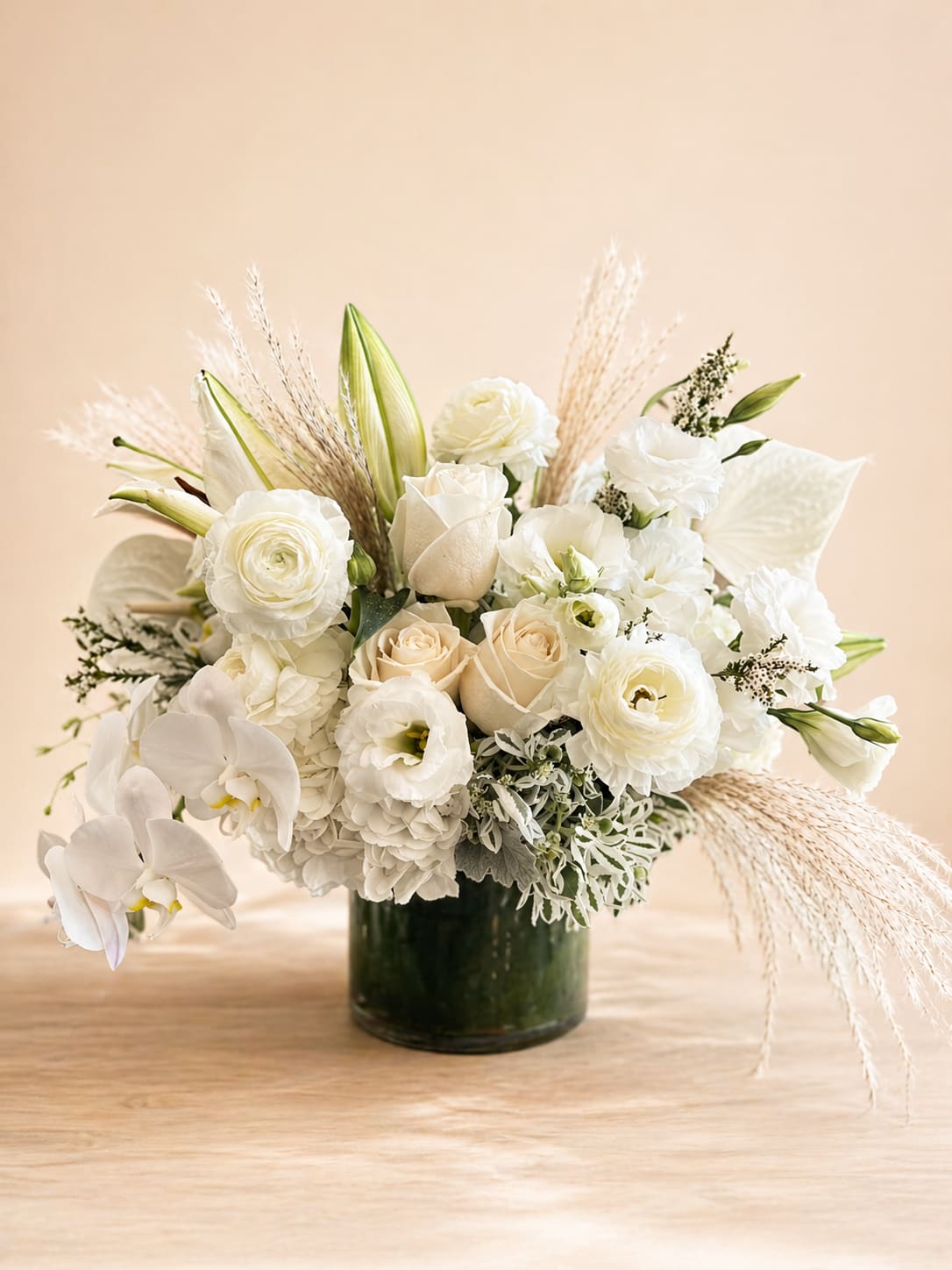White Boho  - Elevate your space with the timeless elegance of our "White Boho" floral arrangement. Florals include, white hydrangea, white anthuriums, white lisianthus, white roses, white ranunculus, white lilies, and California grown pampas grass. 