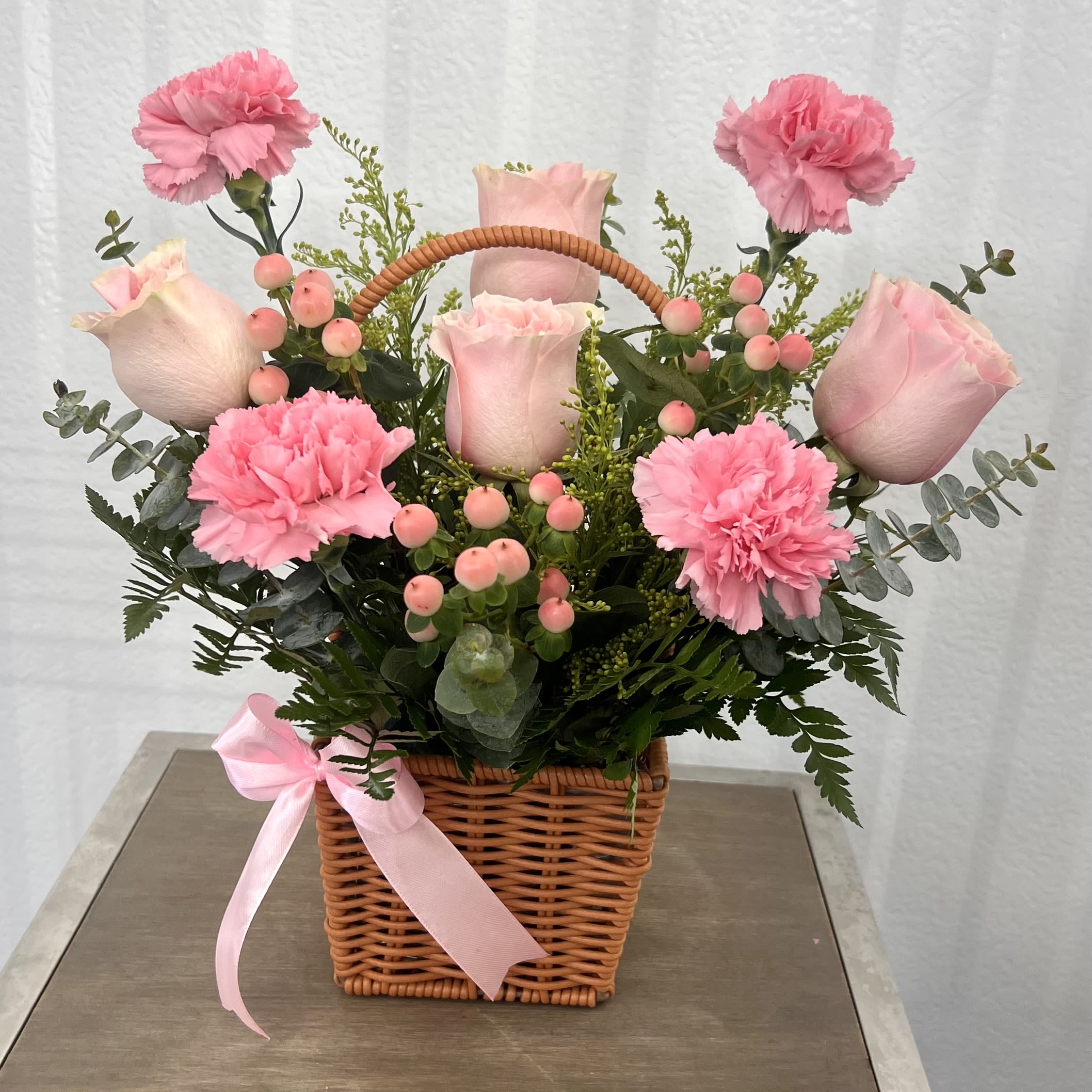 Blush Garden Mini Basket - Light Pink Roses And Carnations - A soft and elegant basket arrangement with blush pink roses, carnations, and hypericum berries, beautifully complemented by fresh greenery. Perfect for sweet, delicate, and loving occasions.