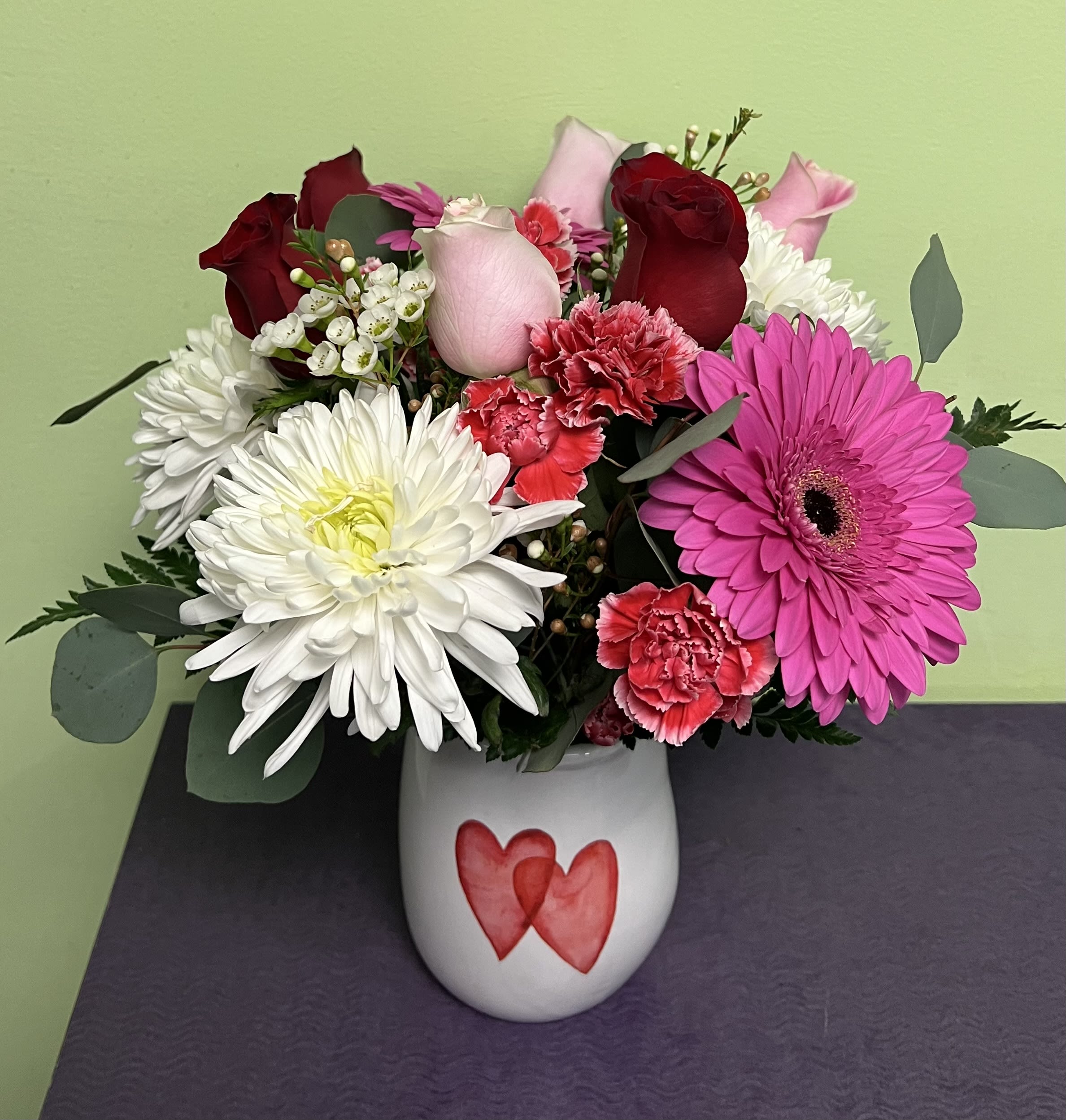 "I Heart You!" - Send your heart to someone on the day that is filled with love. This one of a kind arrangement will arrive in a ceramic vase that pictures either a pink or red heart on the front. Send some love this Valentine's day by saying "I Heart You!"