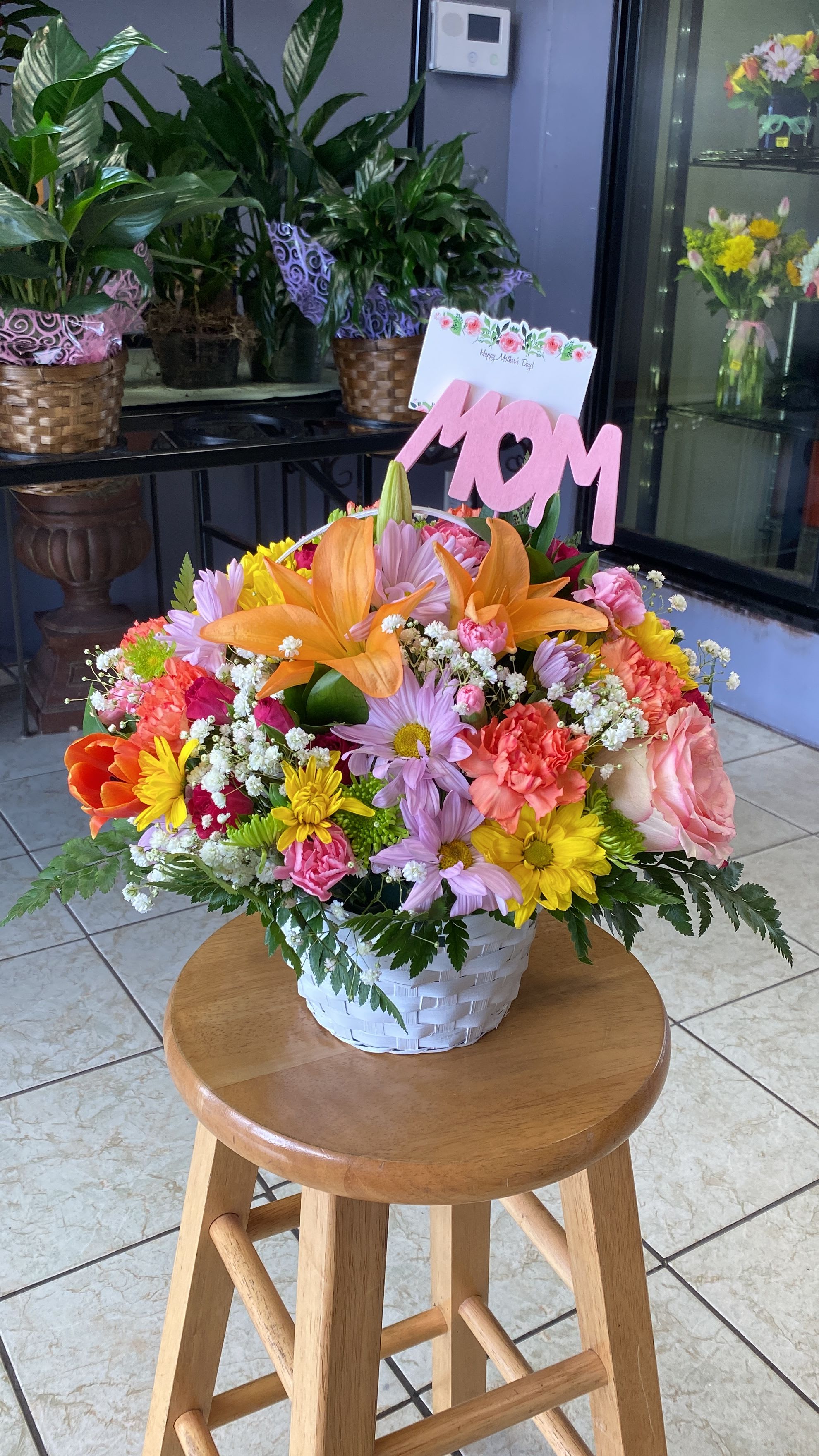 Colorful mixed flower basket with a pink MOM sign