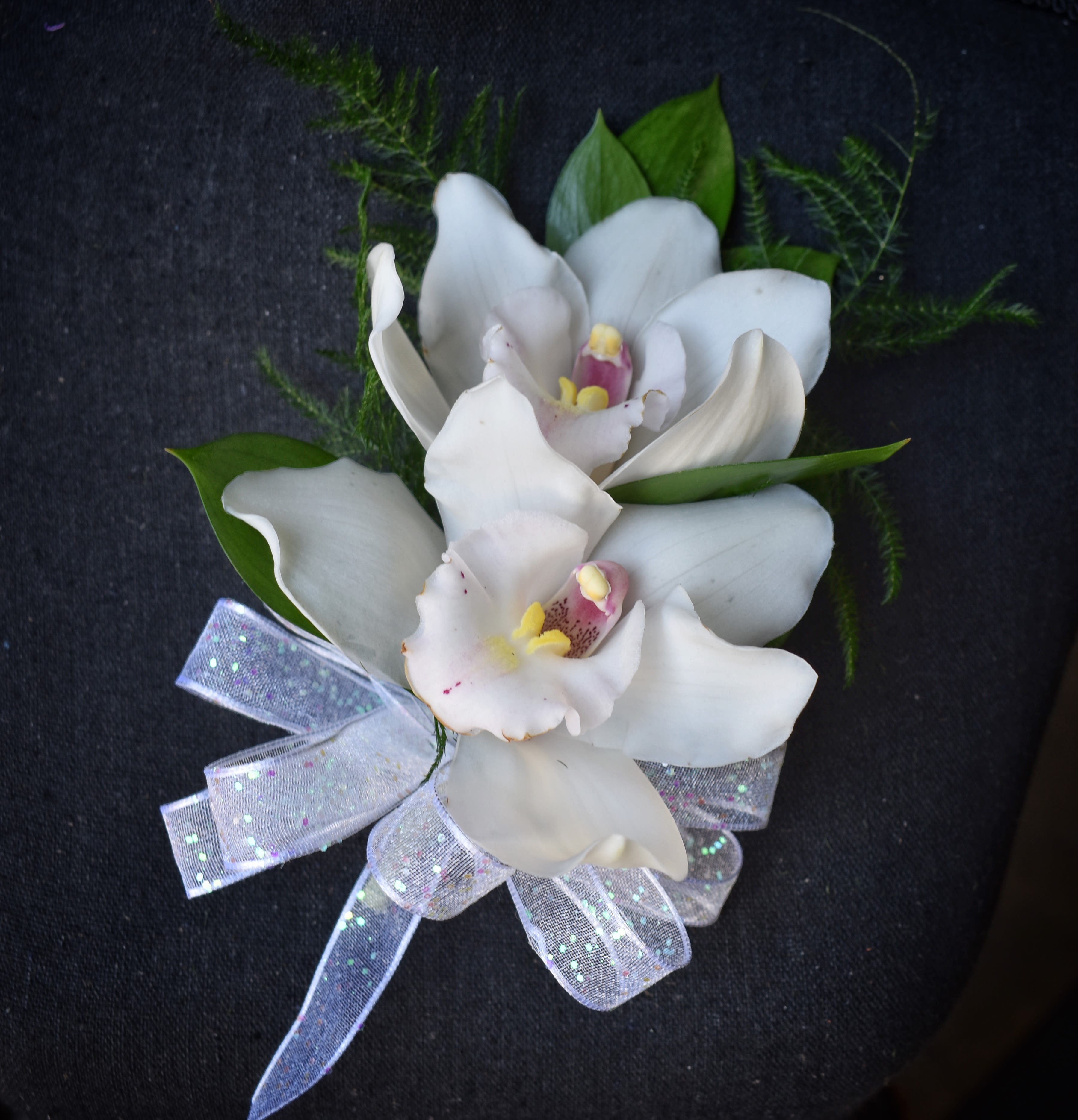 Eastern Star Corsage #6 Double Cymbidium Orchid ** NOT FOR PROM - This corsage s made with 2 full size Cymbidium orchids with greens and a bow. **please not if you’d like a different color, mauve, yellow or white