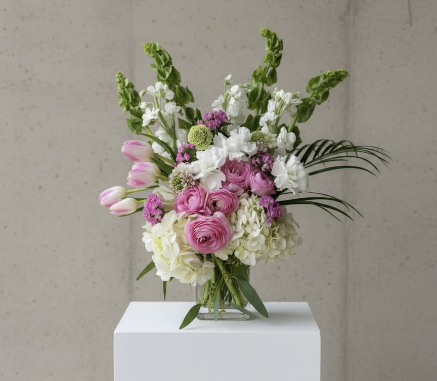 Pink and white mixed bouquet in a clear glass vase