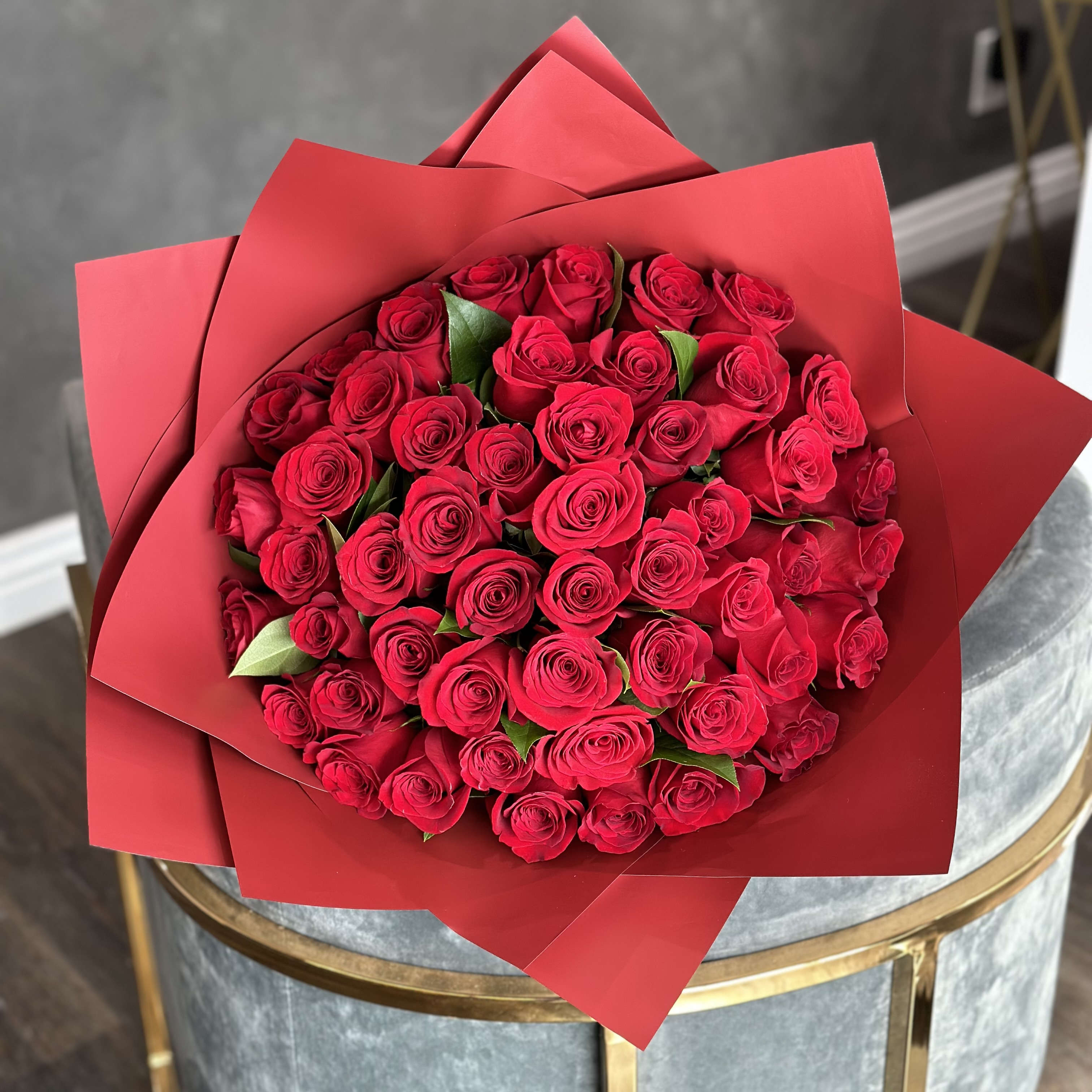 Bouquet of red roses wrapped in red paper