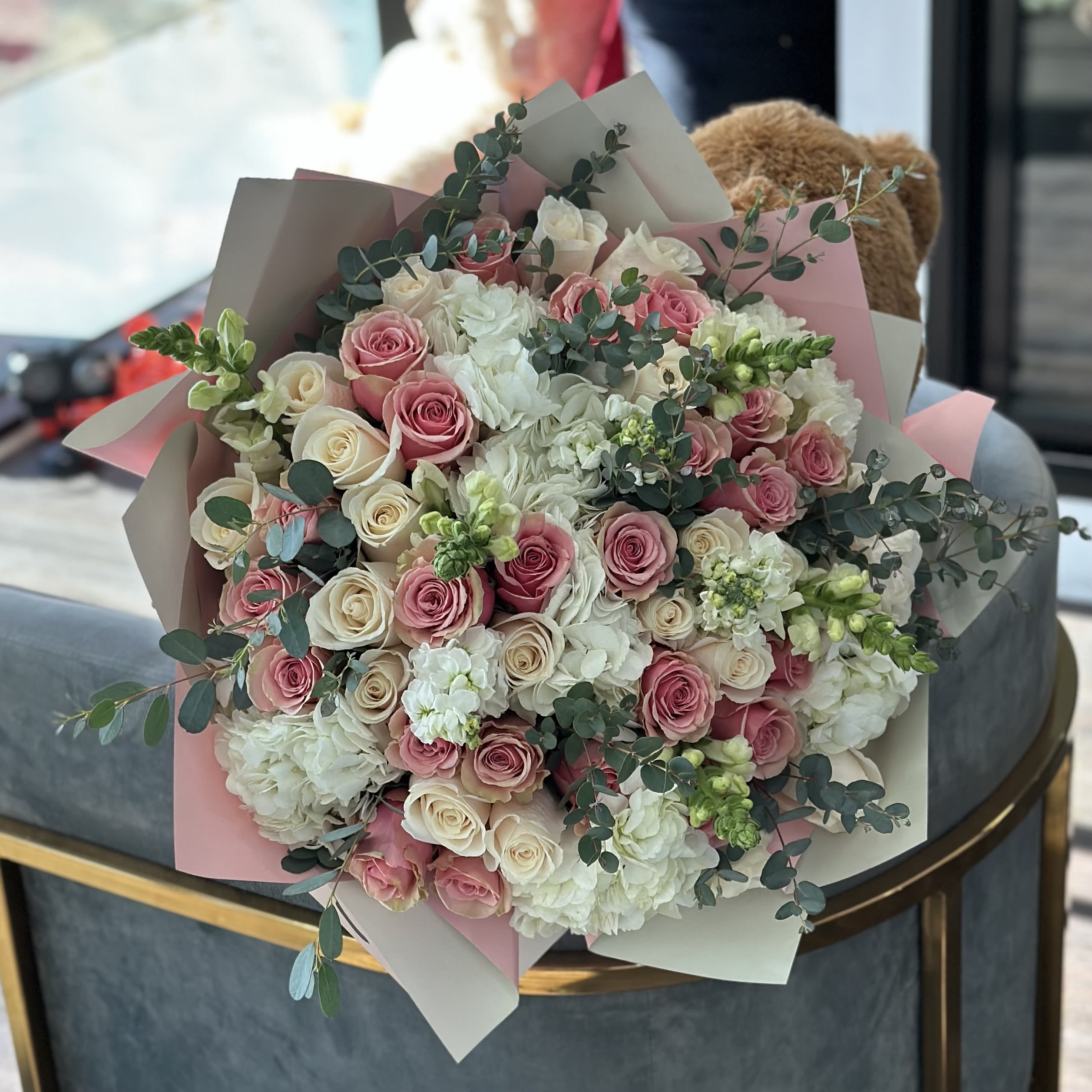 Large bouquet of pink and white roses with white blooms and eucalyptus