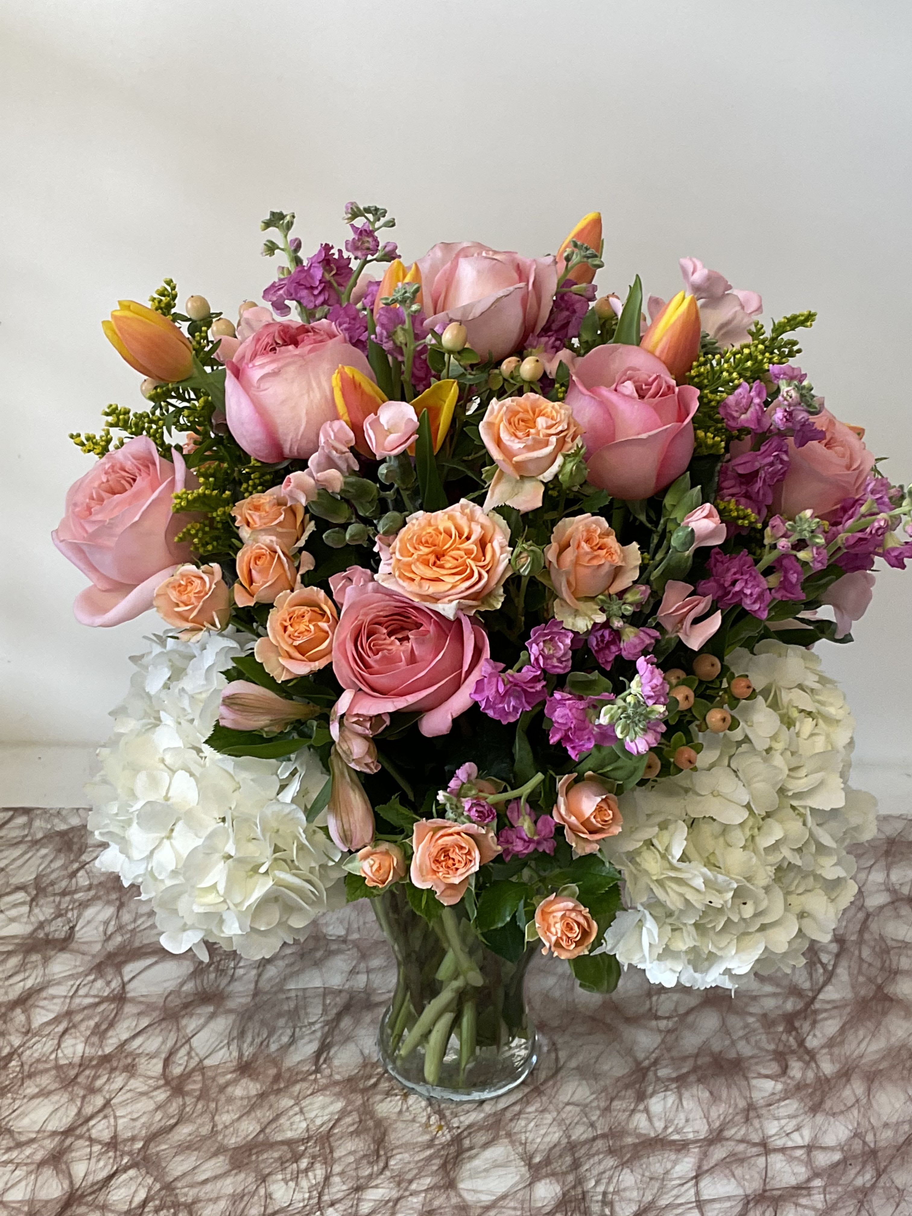 The Mother’s Day $200 Mixed Arrangement - Mixed colors of mixed flowers, beautifully arranged is a chic clear vase!