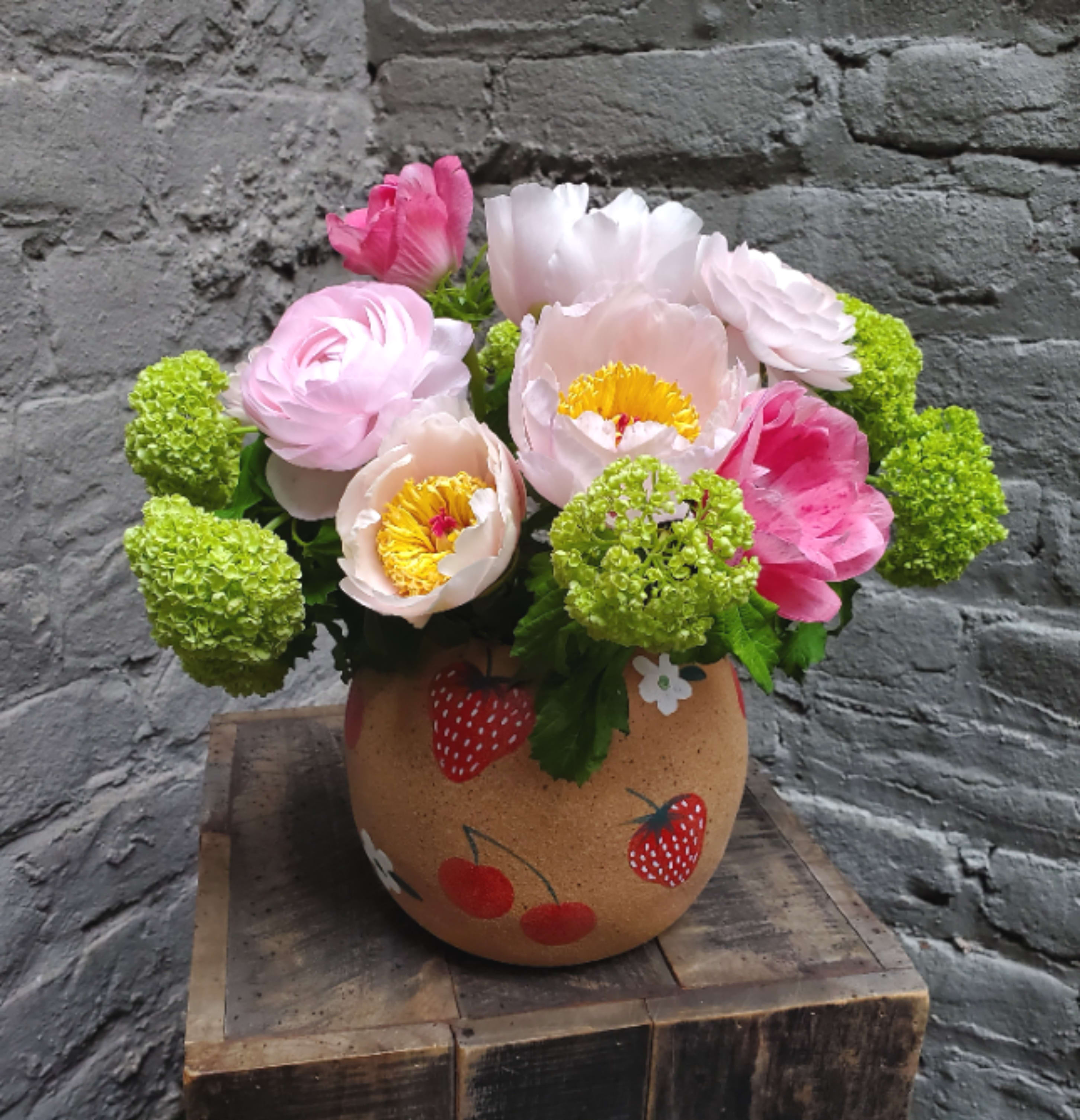 Strawberry Season - This arrangement is sweeter than shortcake!  A darling medley of local peonies, ranunculus, and viburnum -- in a cute-as-a-button rounded terracotta vase with painted berries.
