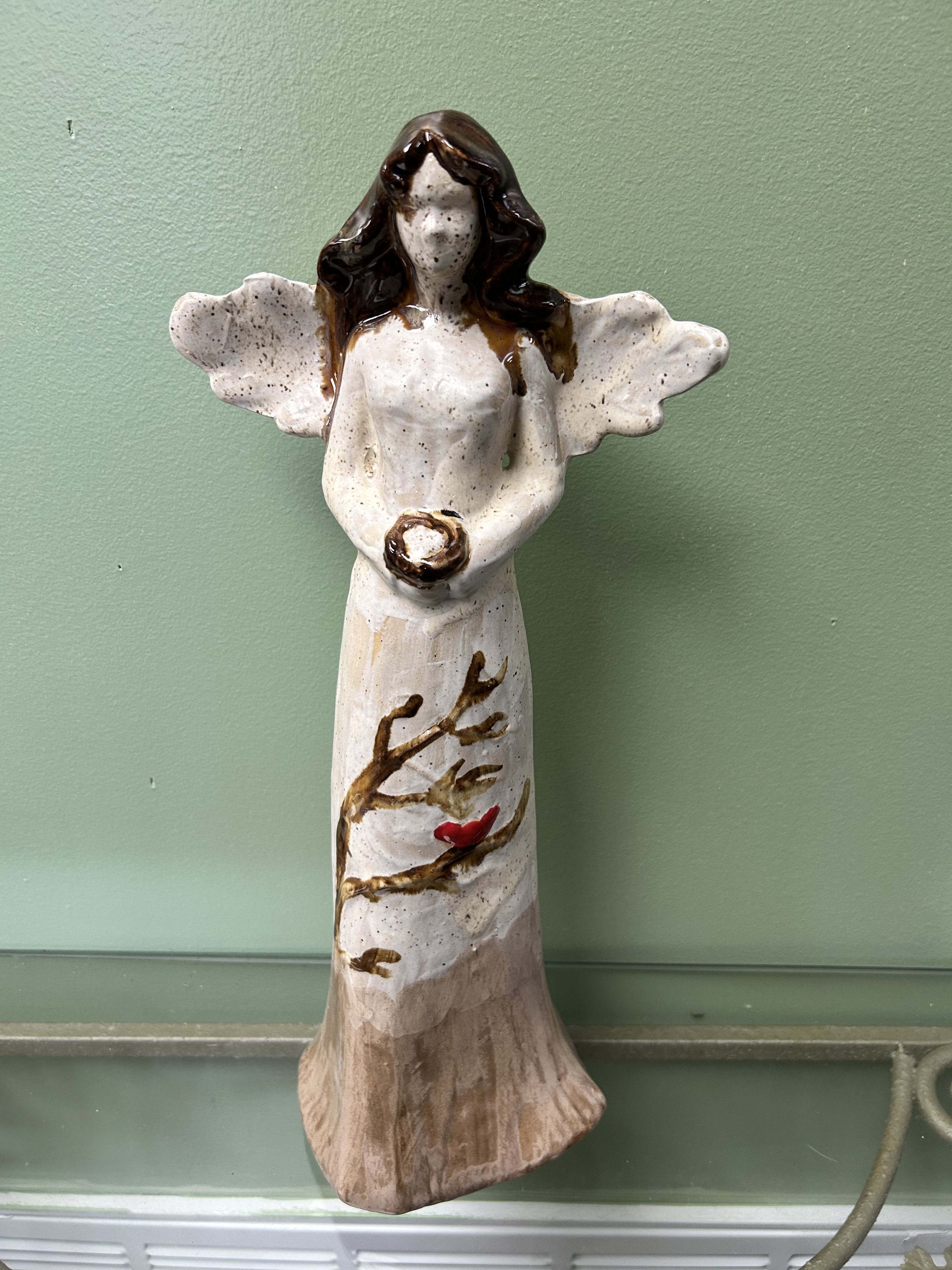 XL Pottery Angel - This beautiful angel is 17 inches tall and features a beautiful redbird perched on the trees that flow on her dress. This is a wonderfully crafted piece from a local artist.