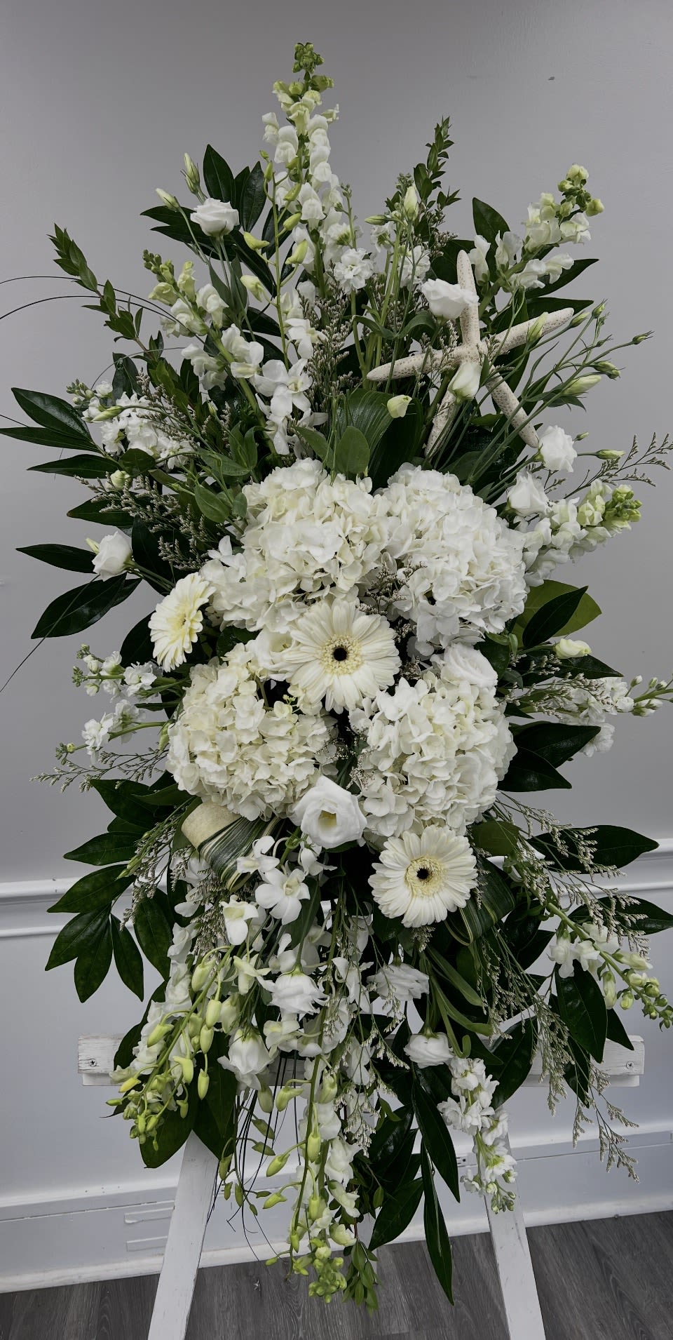 Sympathy: Standing Spray -  We will make you a beautiful arrangement in your price range using the freshest flowers available at the market on the morning of your order. For Specific details on flower availability please call our store directly. 