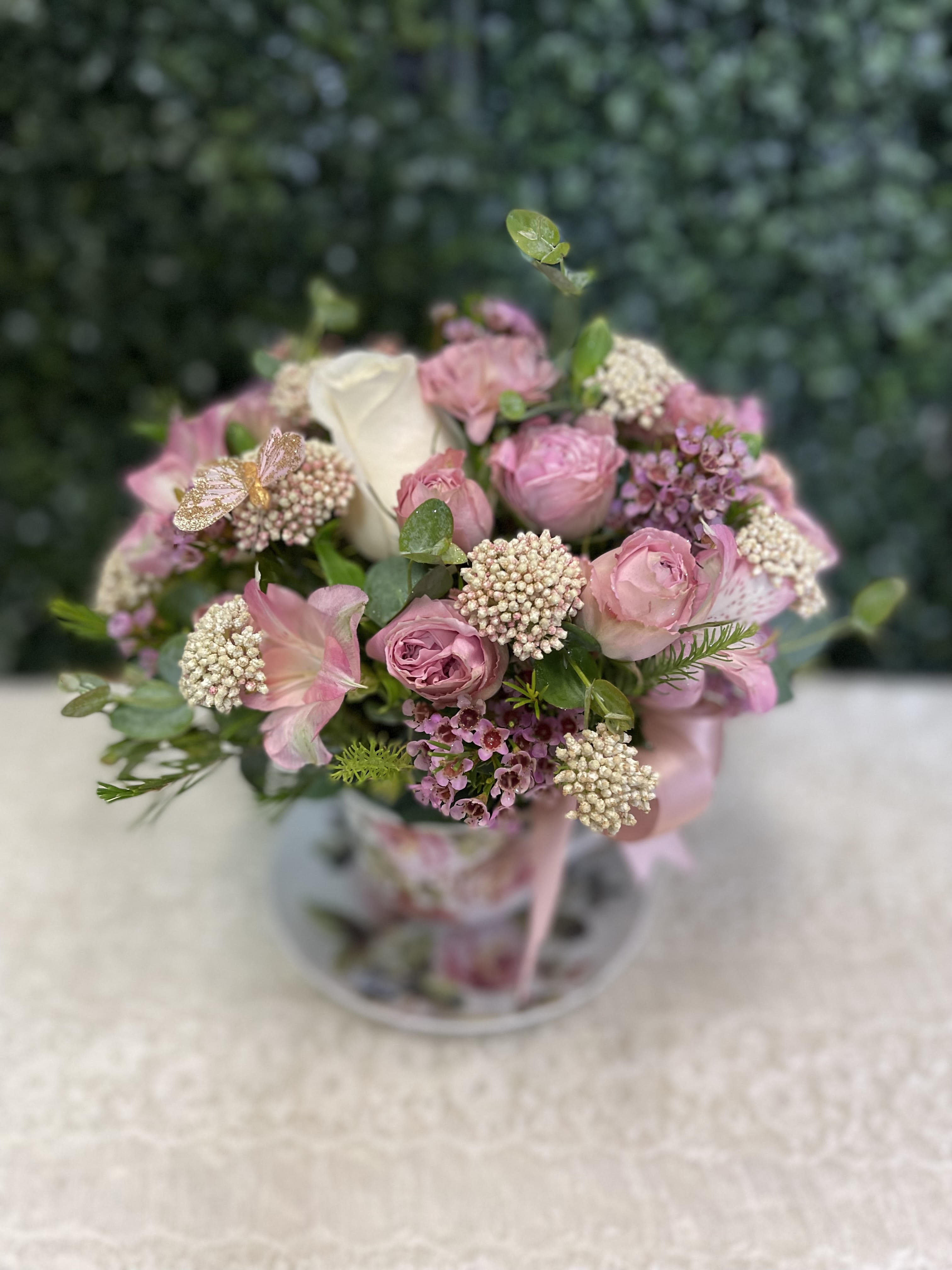 Pink and white bouquet with roses in a clear vase