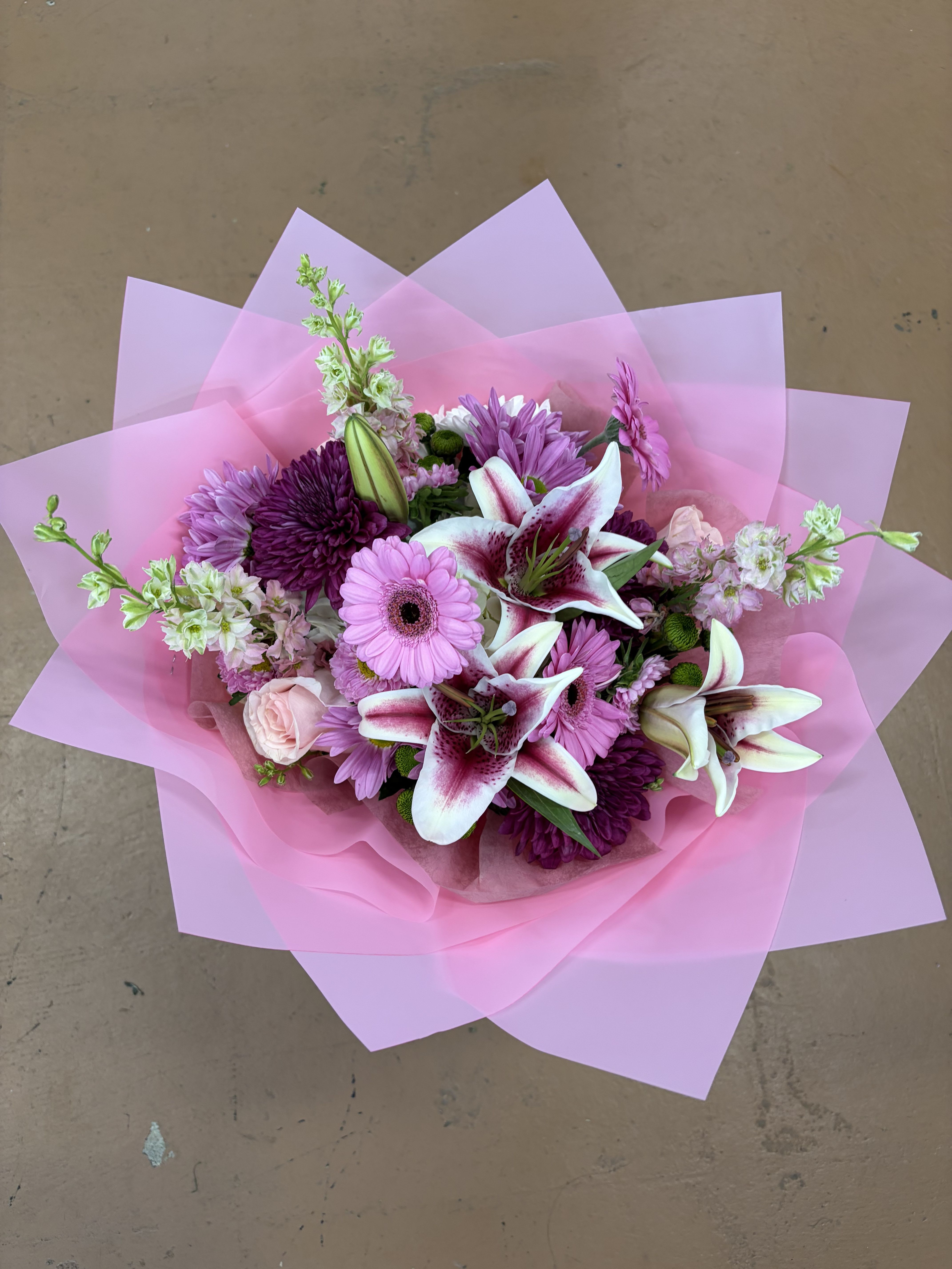 Pink Velvet Harmony Bouquet  - A soft and elegant arrangement with layered pink tones and rich accents that create a balanced, eye-catching design. Wrapped in delicate paper, it gives a warm, romantic feel and makes a beautiful gift for celebrations, appreciation, or simply brightening someone’s day.