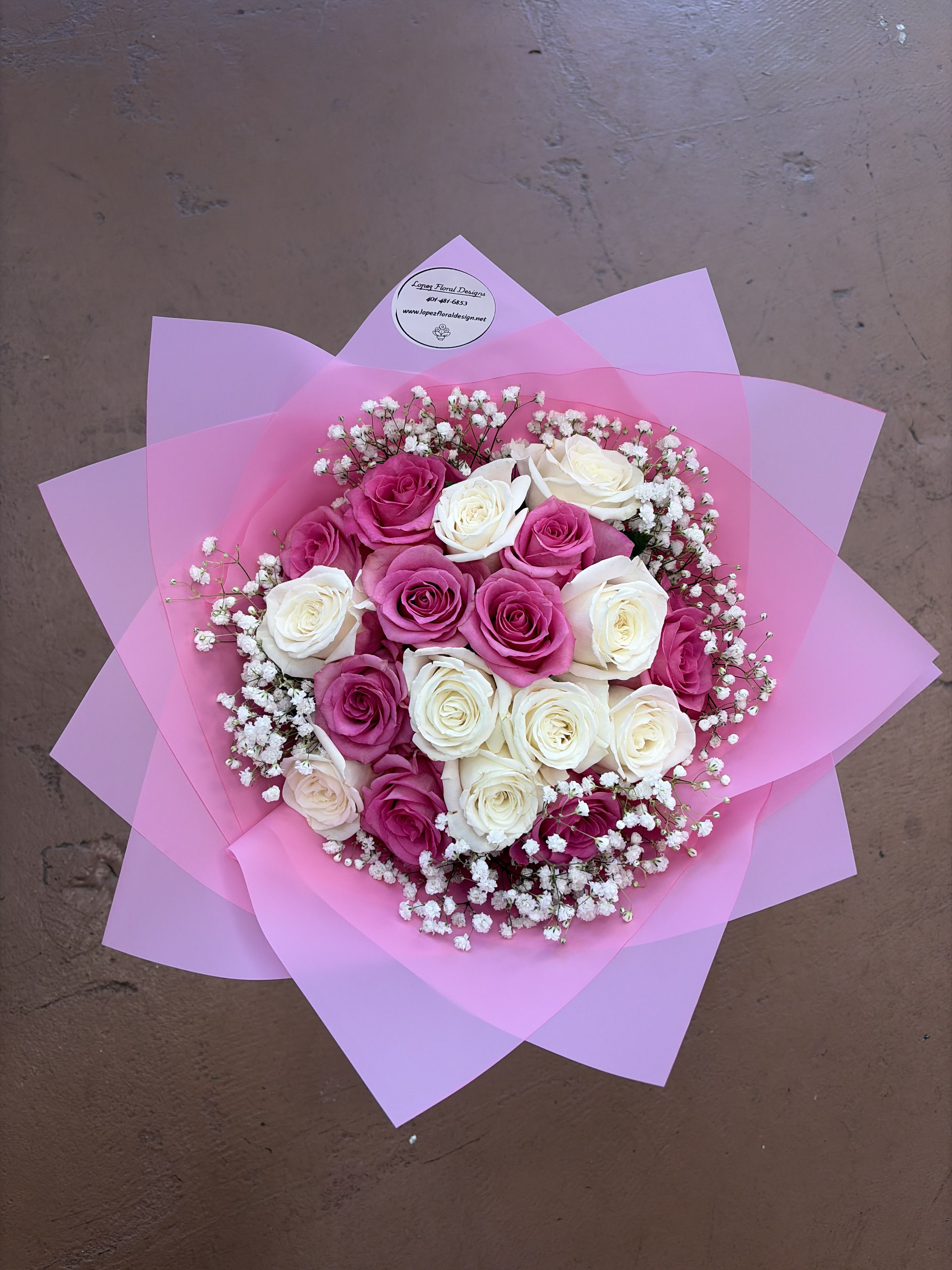 18 white and pink rose bouquet  - A classic arrangement featuring eighteen soft pink and white blooms arranged in a full, rounded design. Surrounded by delicate accents and wrapped in layered blush paper, this bouquet creates a sweet and elegant look that is perfect for celebrating love, appreciation, or special moments.