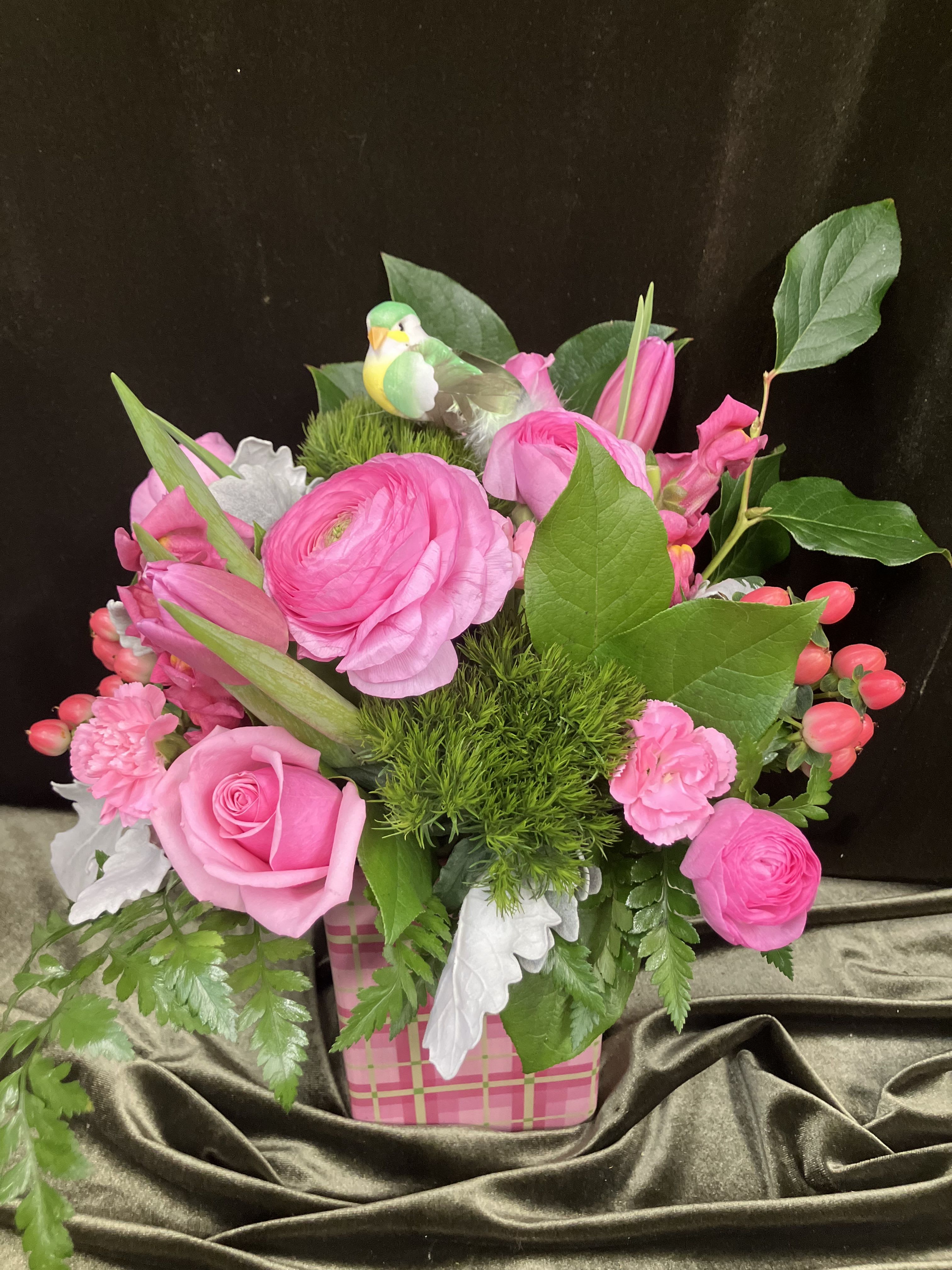 Pink Plaid  - Fresh flowers feature pink ranunculus, tulips, roses and mini carns accents with green dianthus in a cute container 