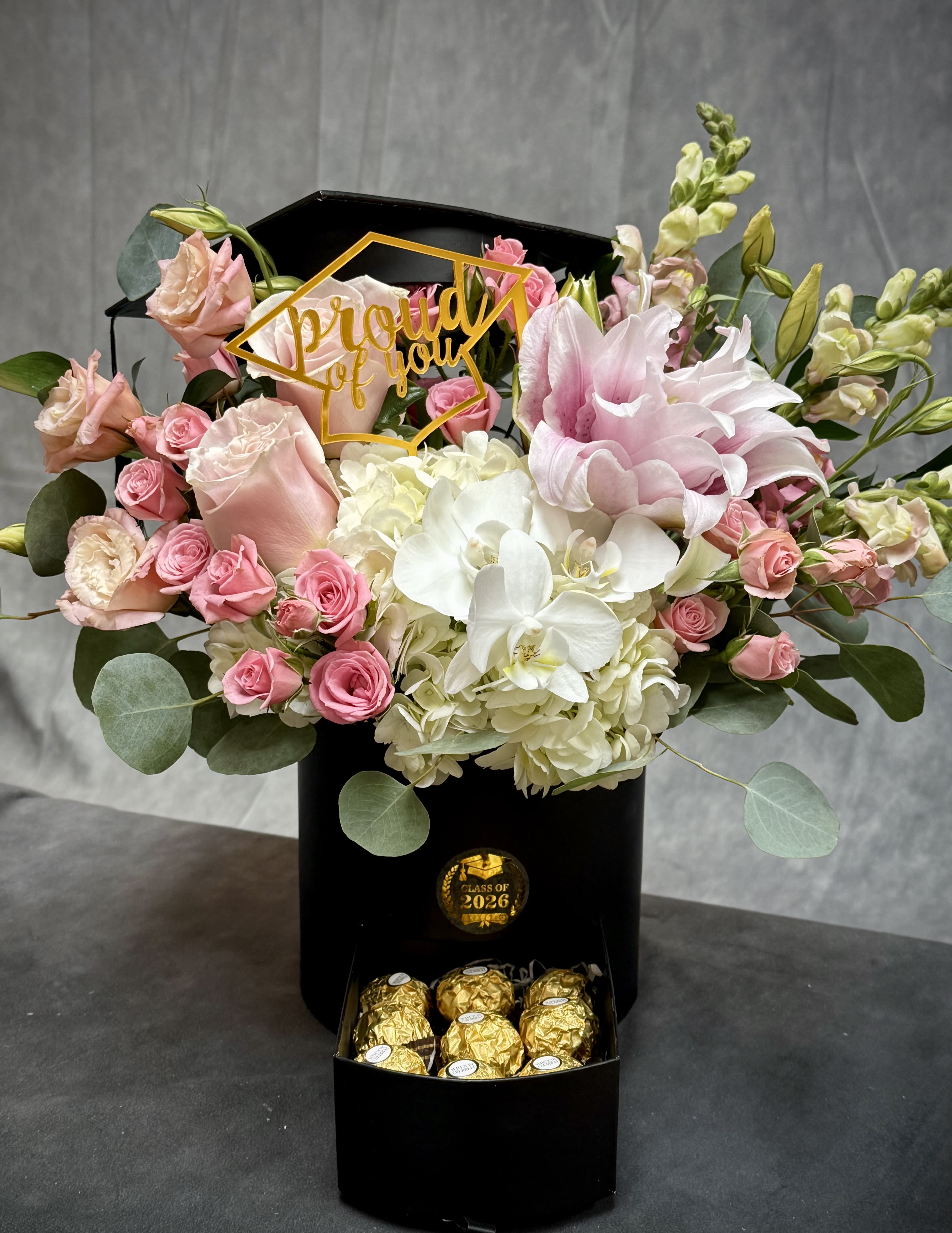 Blooms and Sweet Grad Box  - A sweet and elegant way to celebrate their big achievement  Our Bloom &amp; Sweet Grad Box features a beautiful mix of fresh blush and white florals paired with a graduation-themed topper, all arranged in a luxe keepsake box. The hidden drawer is filled with delicious chocolates for an extra special touch—because every success deserves something sweet! 