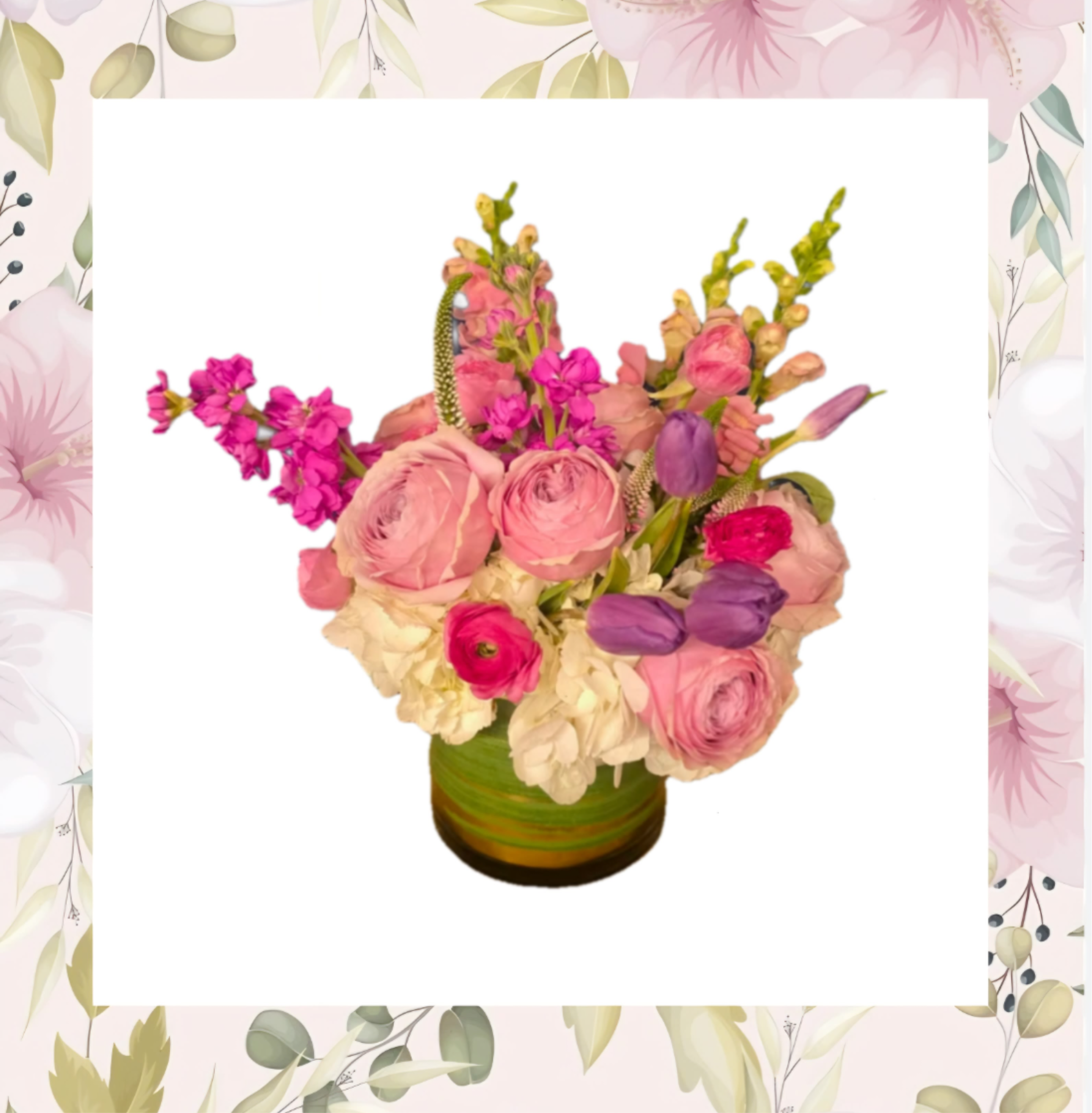 Pink and purple mixed flower arrangement in a green vase