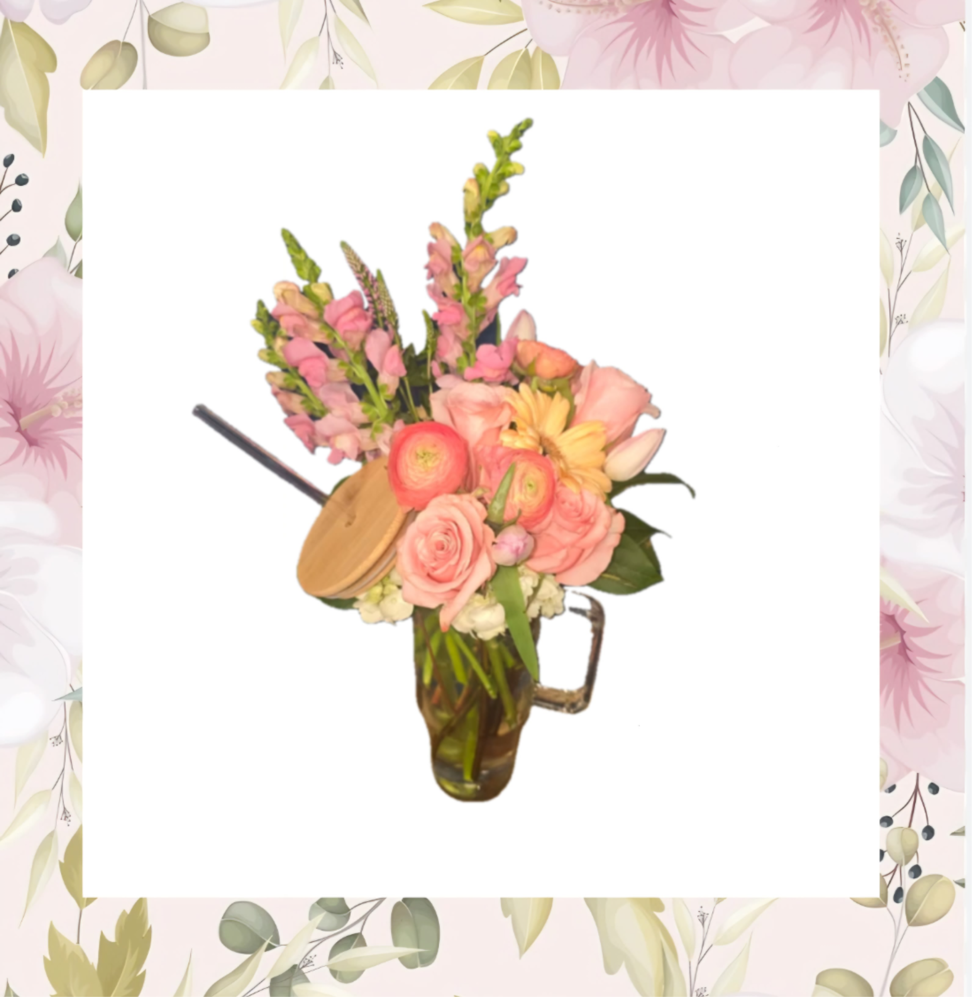 Pink and peach flowers arranged in a glass mug vase