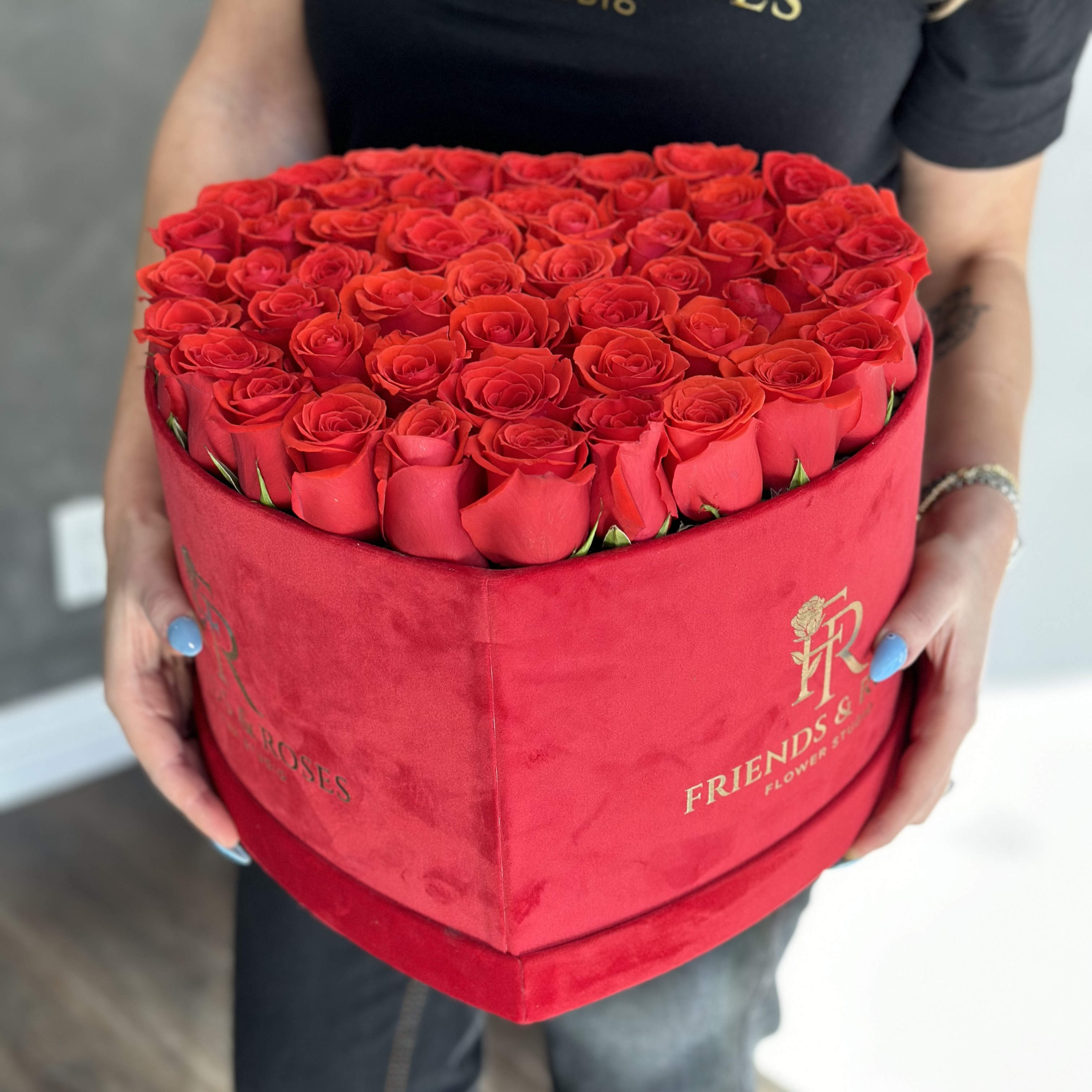 Heart-shaped box filled with red roses