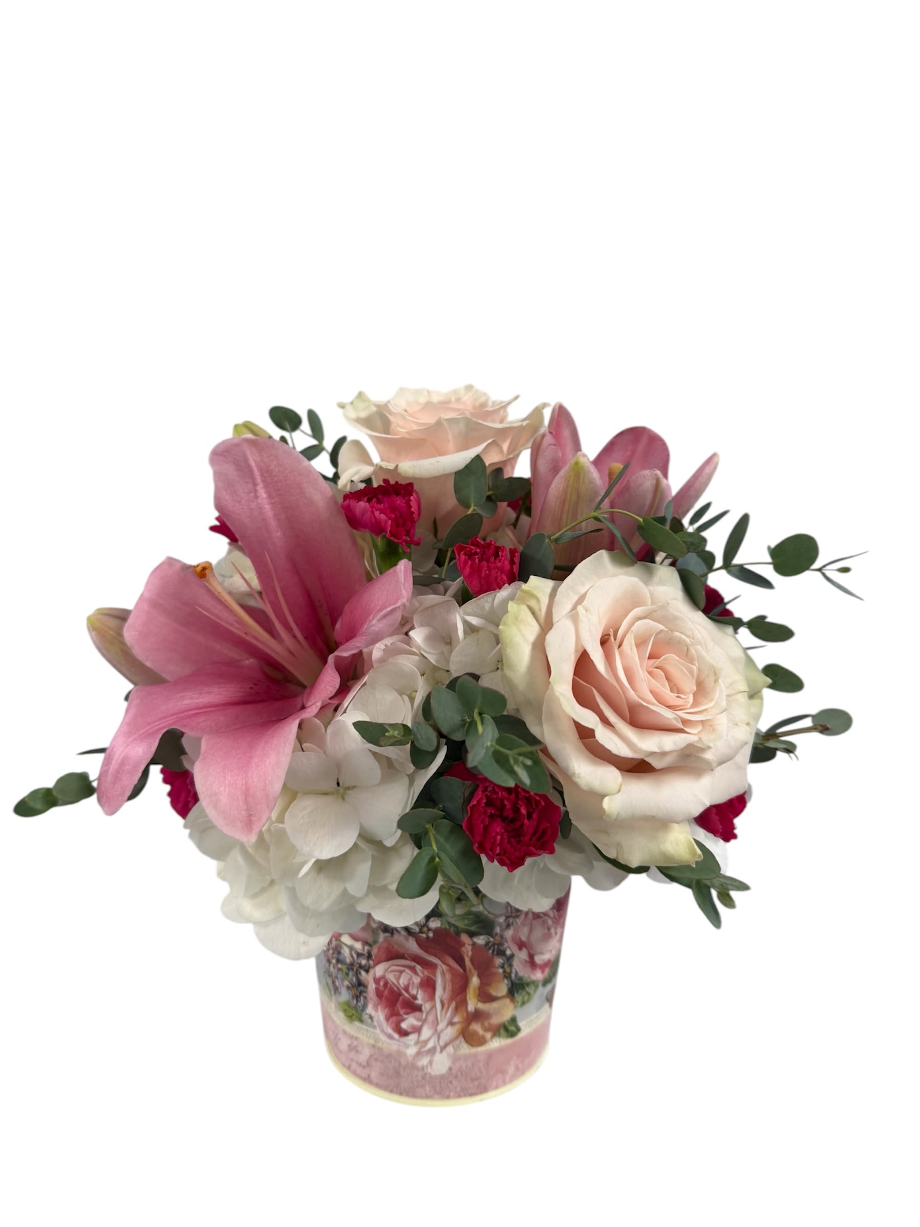 Vintage Blush Arrangement - A soft pink lily takes center stage in this Vintage Blush arrangement, creating an immediate impression of romance and tenderness - perfect as a birthday bouquet, anniversary arrangement, or a thinking-of-you gift. The combination of pale blush roses and creamy white hydrangeas gives a lush, vintage feel while the pops of small hot pink minicarnations lend a gentle warmth that reads both classic and personal for someone you want to make feel cherished. 