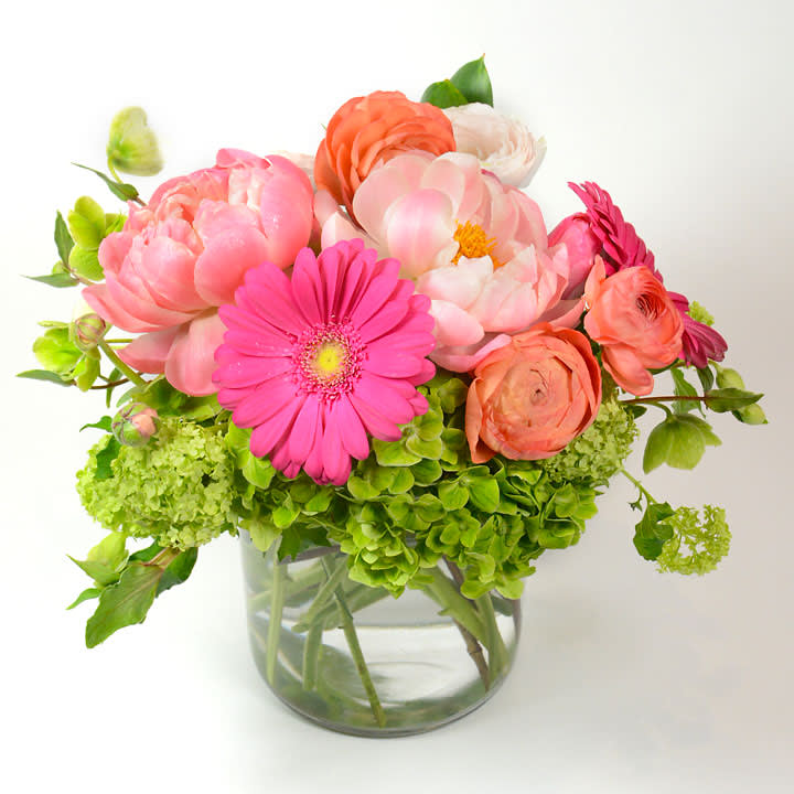 Pink and coral mixed bouquet in a clear glass vase